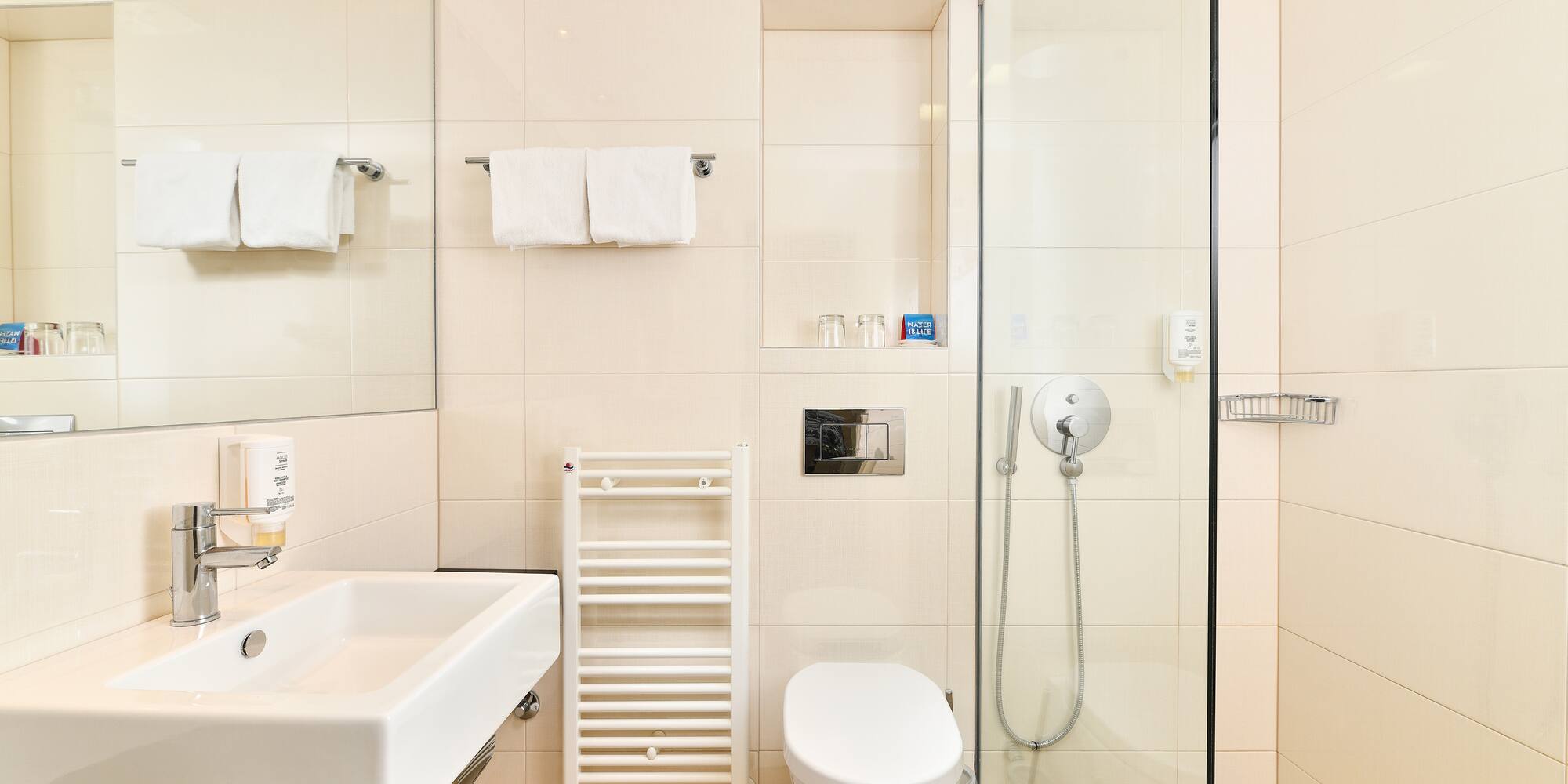 a bathroom with a glass shower and toilet