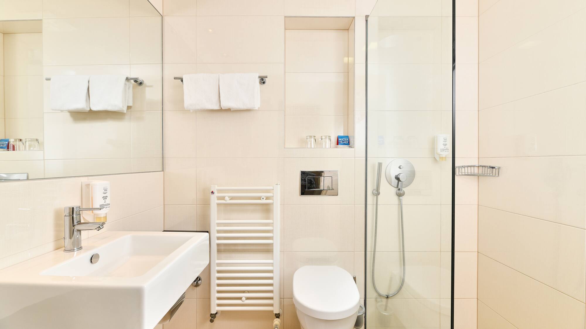 a bathroom with a glass shower and toilet