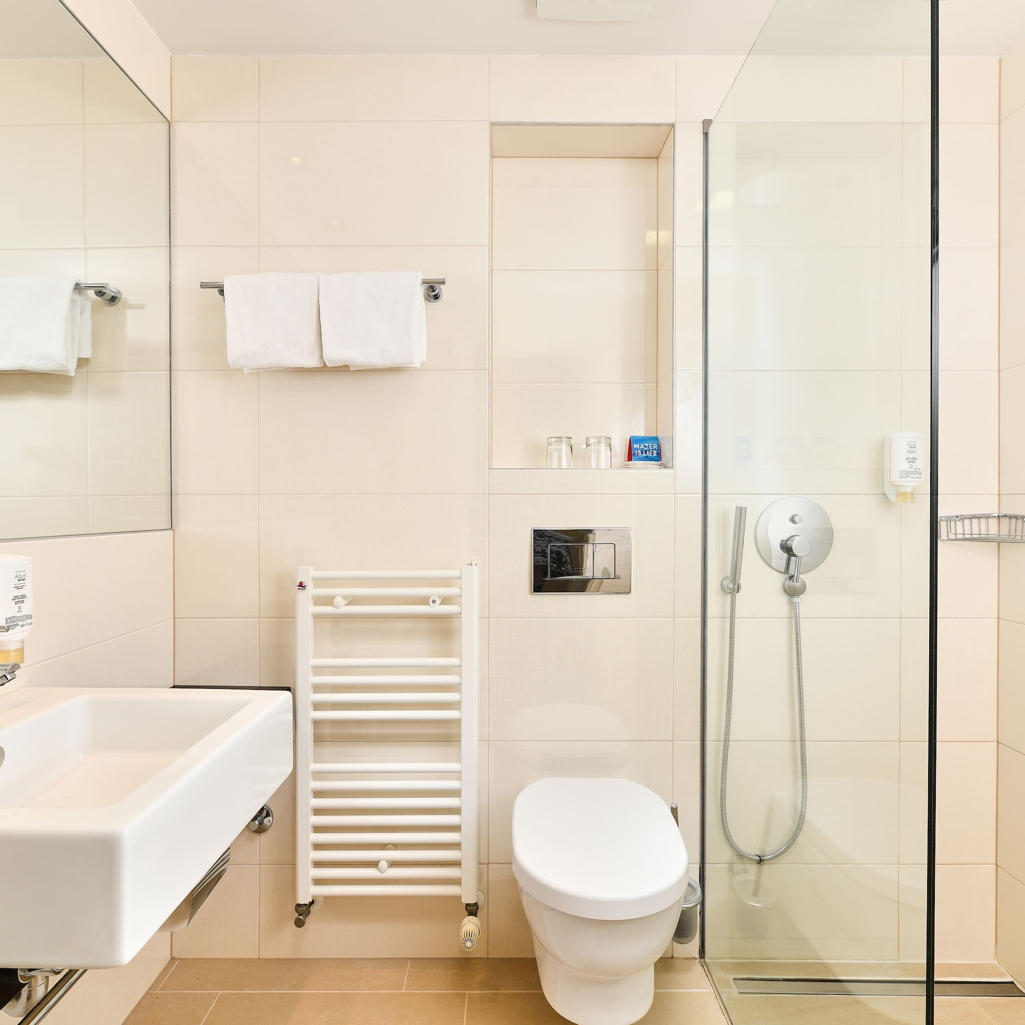 a bathroom with a glass shower and toilet