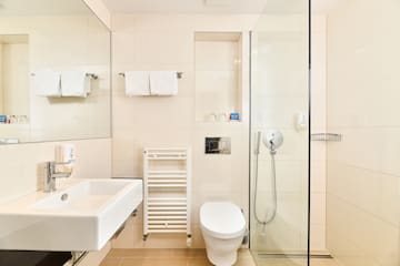 a bathroom with a glass shower and toilet