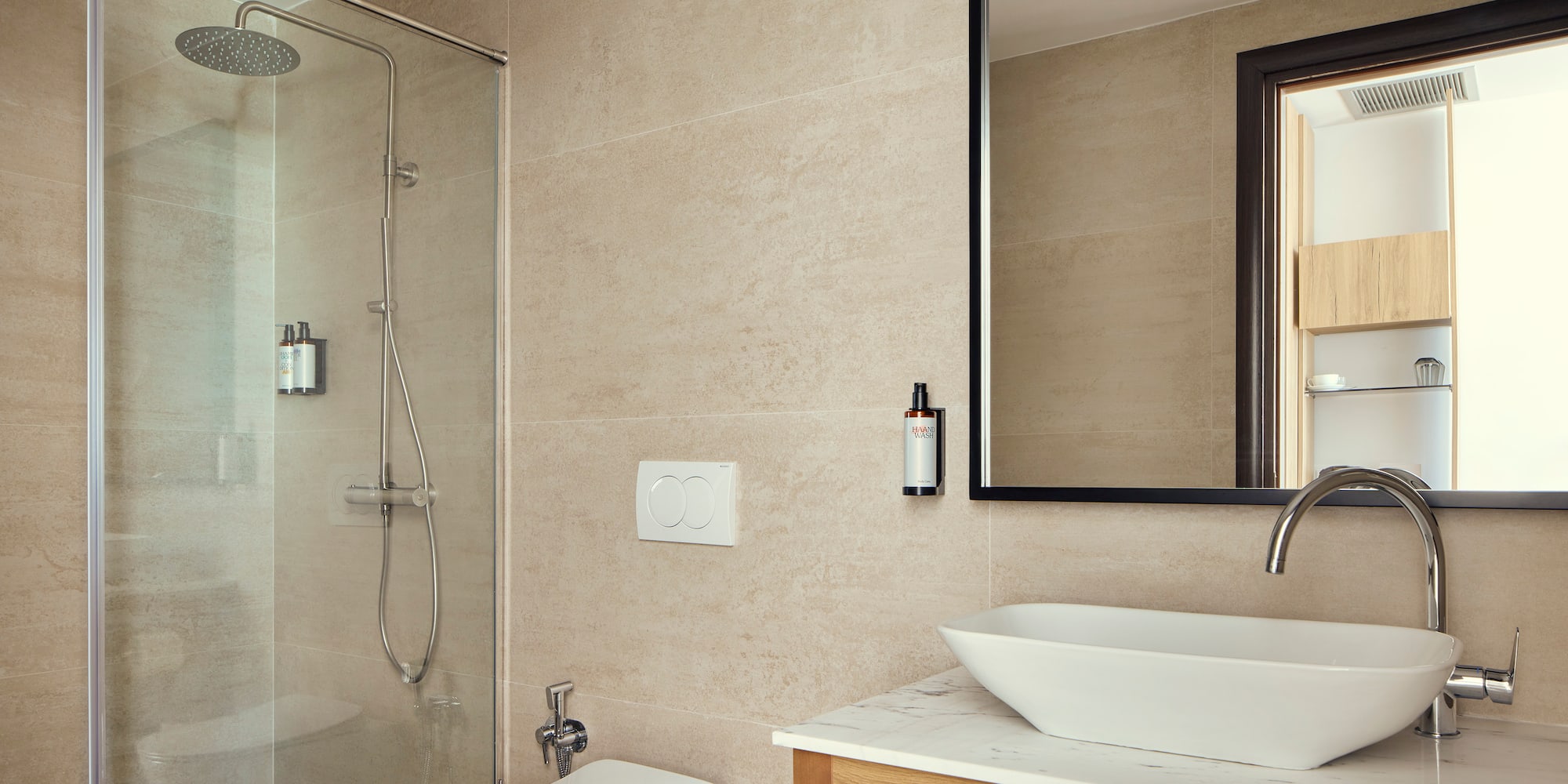 a bathroom with a glass shower and sink