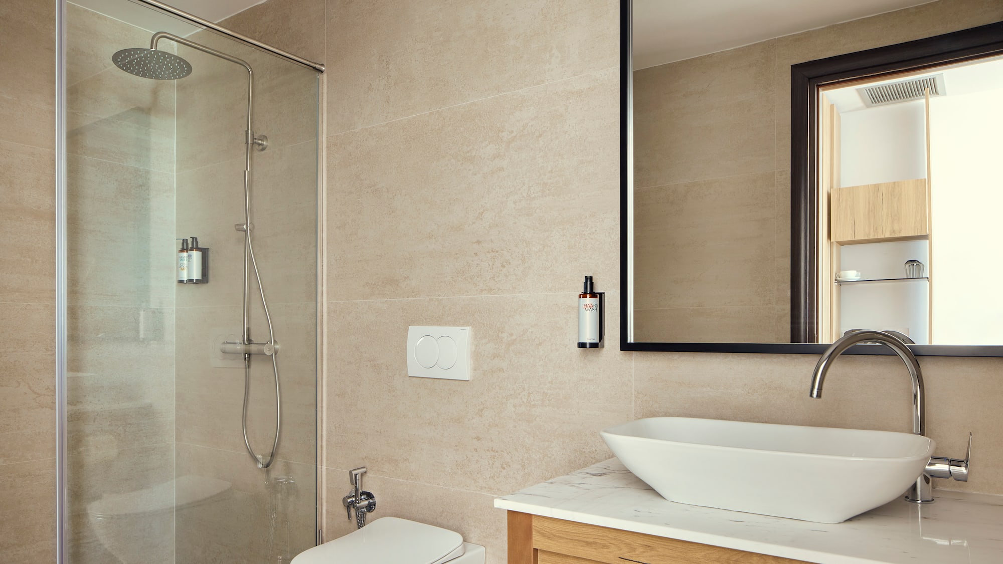 a bathroom with a glass shower and sink