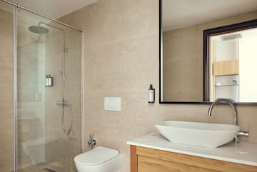a bathroom with a glass shower and sink