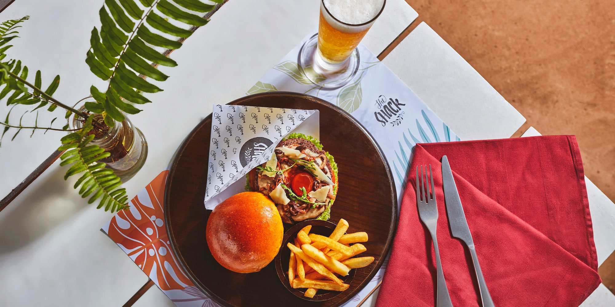 a plate of food and a glass of beer on a table