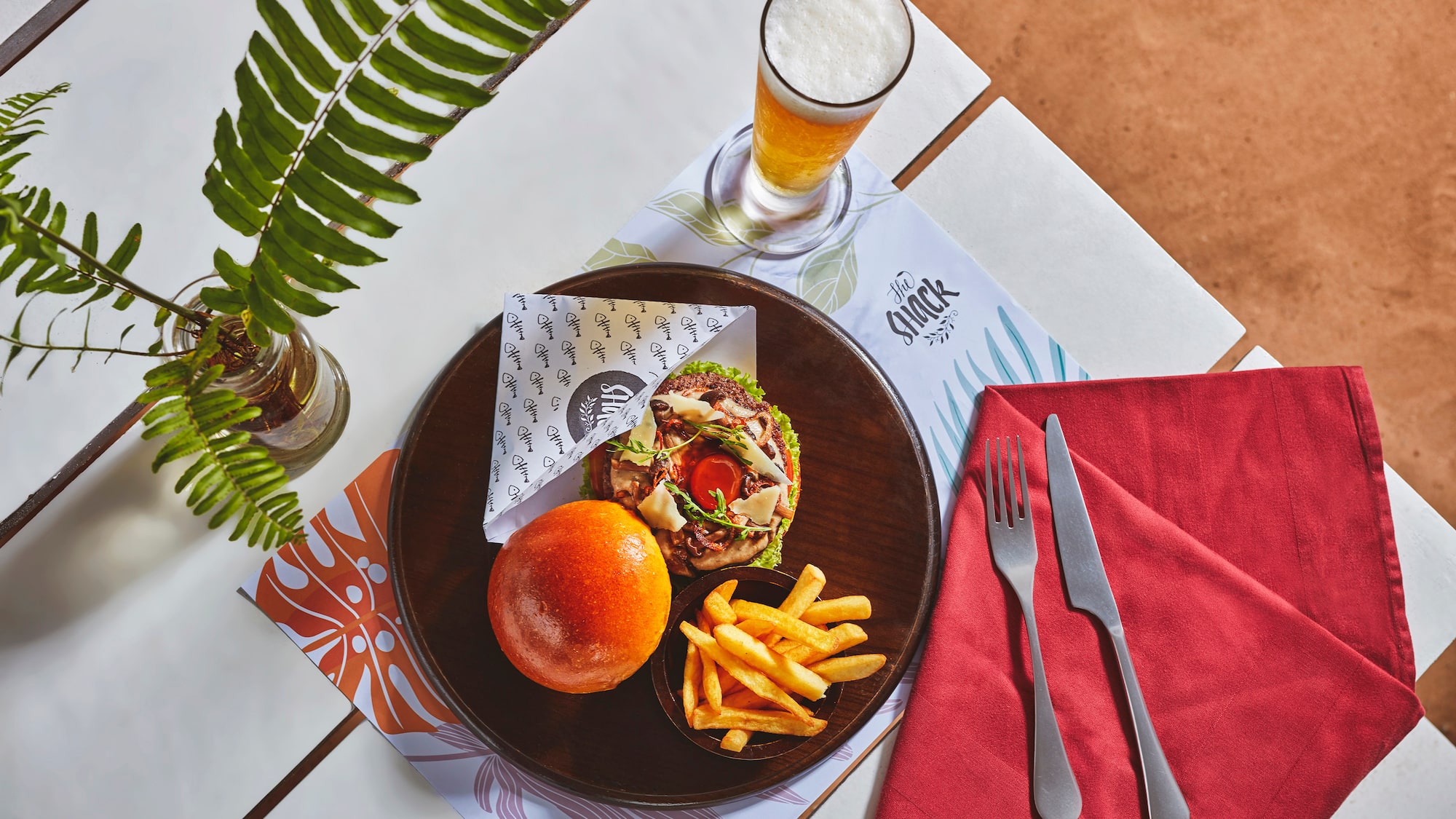 a plate of food and a glass of beer on a table