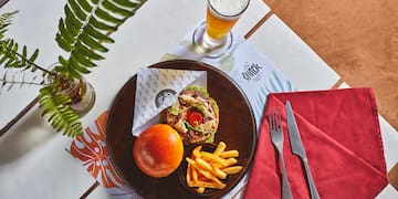 a plate of food and a glass of beer on a table