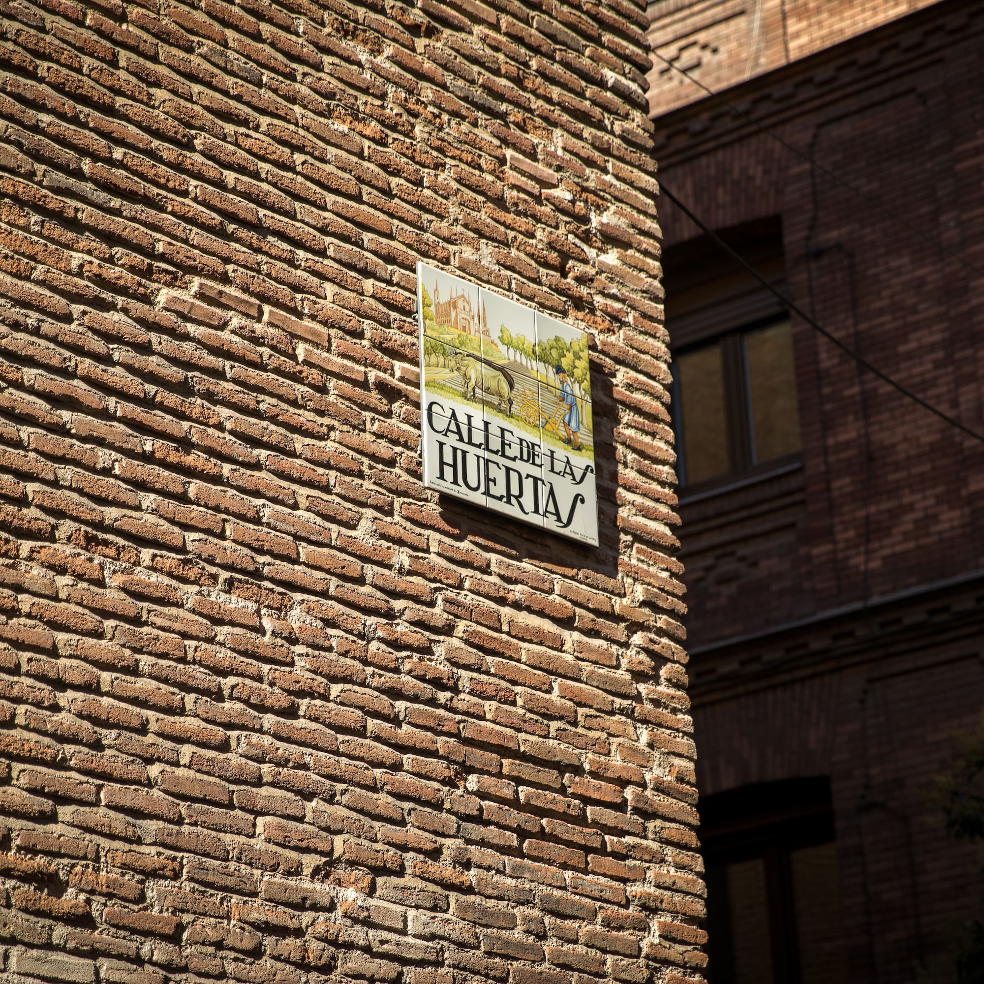 a sign on a brick wall