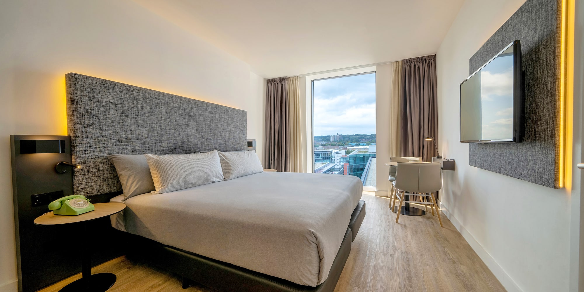 a bedroom with a large bed and a television