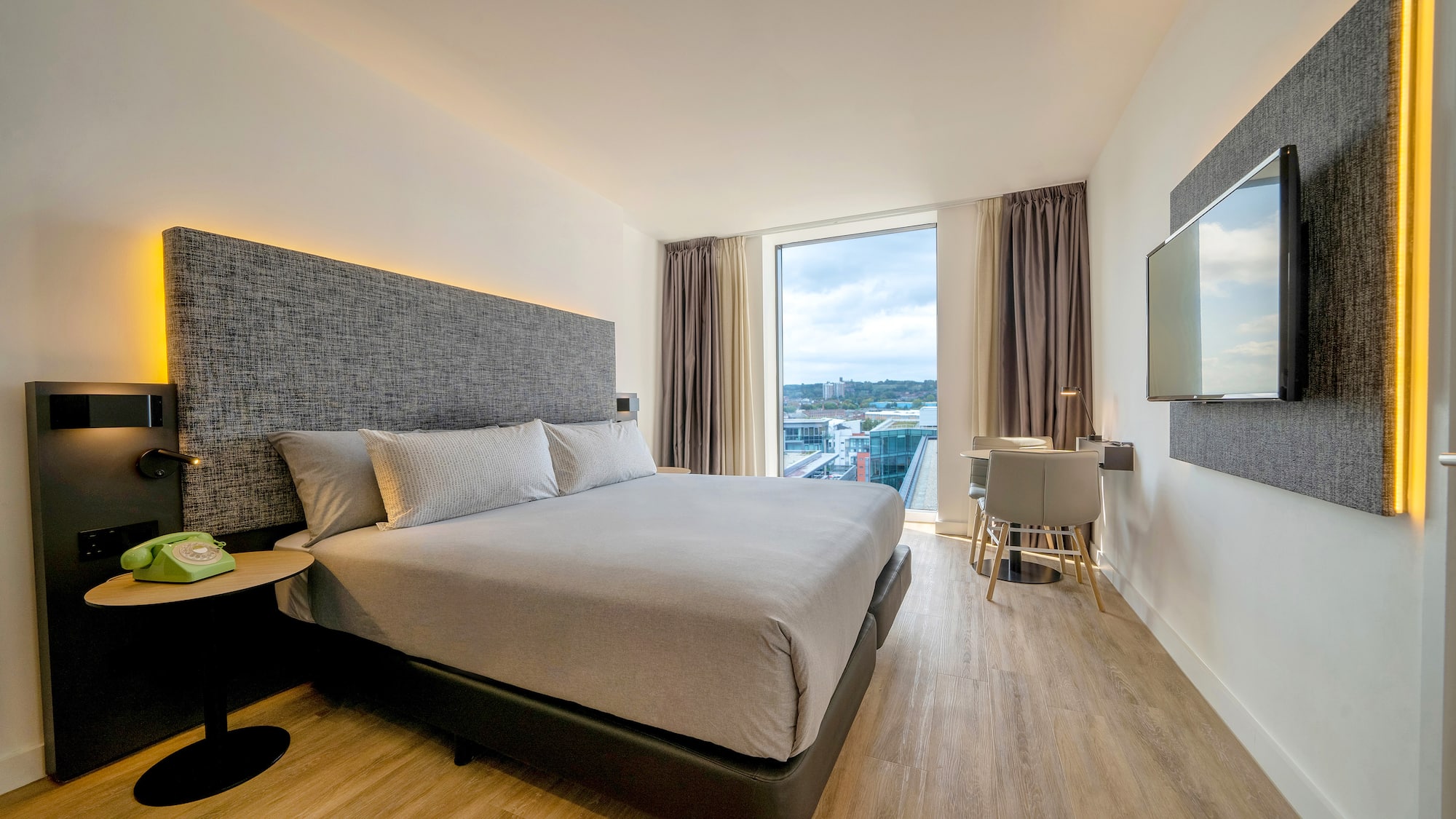 a bedroom with a large bed and a television