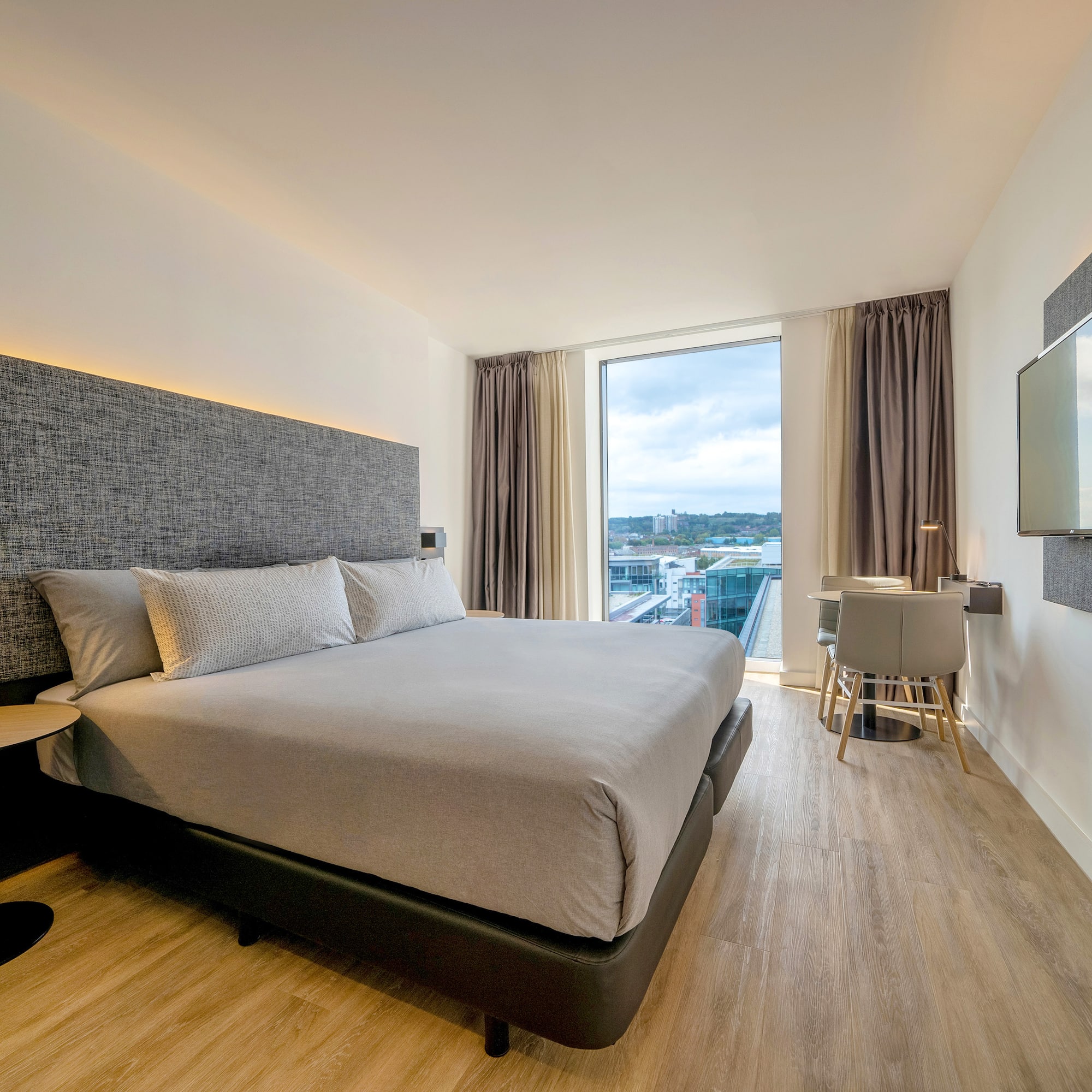 a bedroom with a large bed and a television