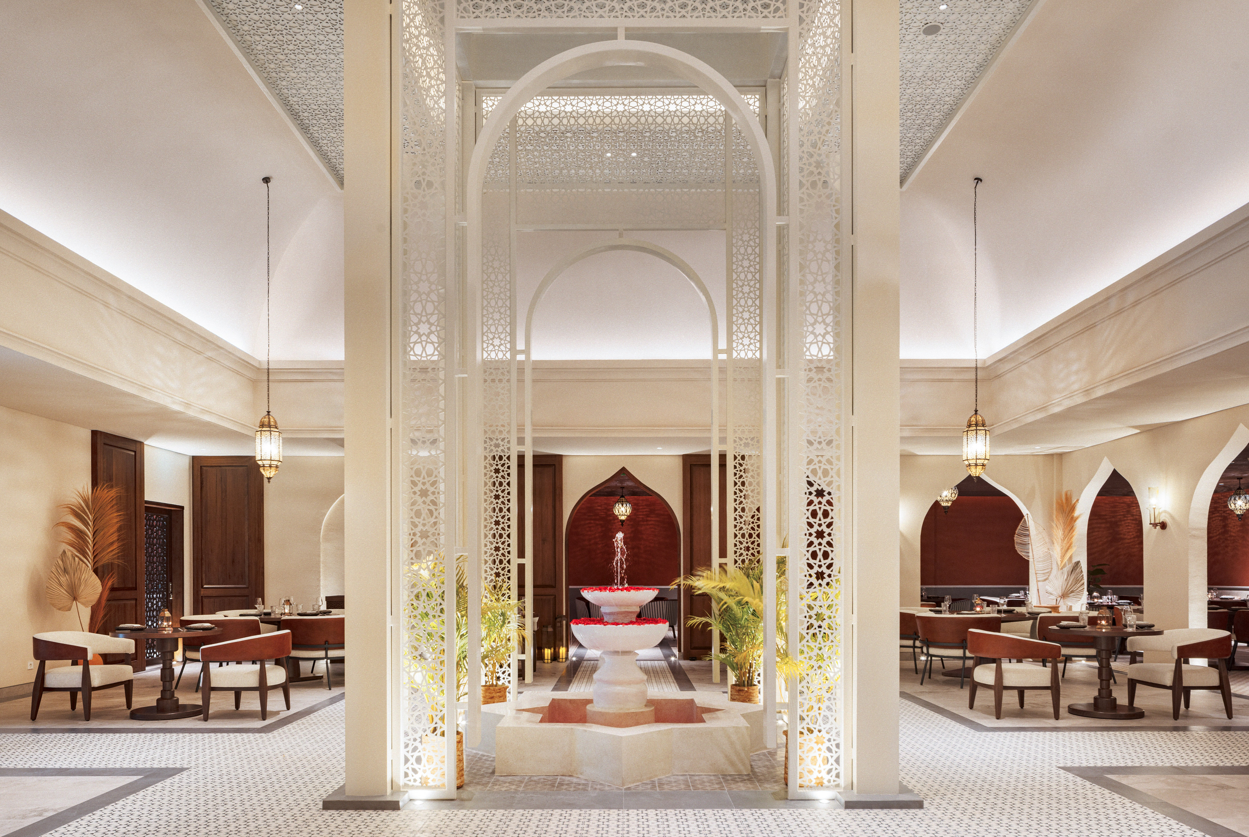 a room with a fountain and tables