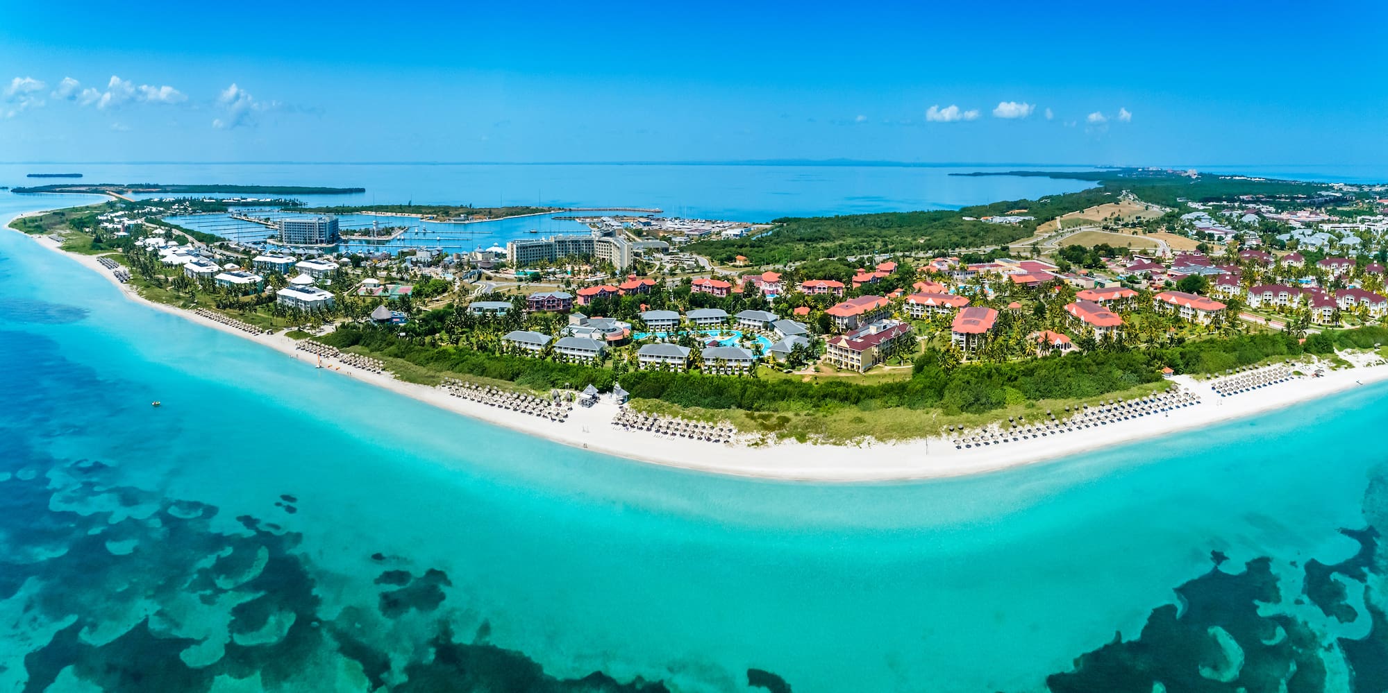 a beach with buildings and a body of water