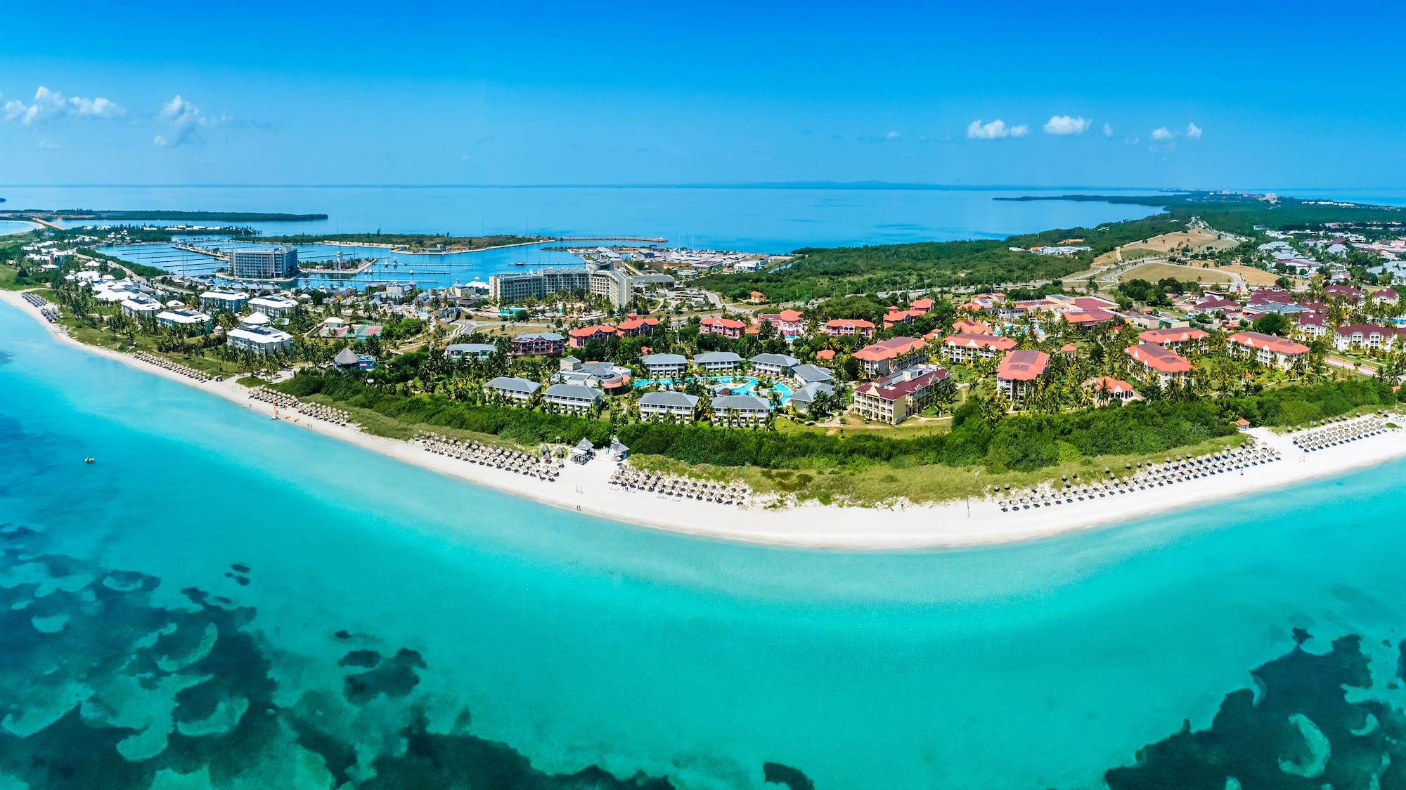 a beach with buildings and a body of water
