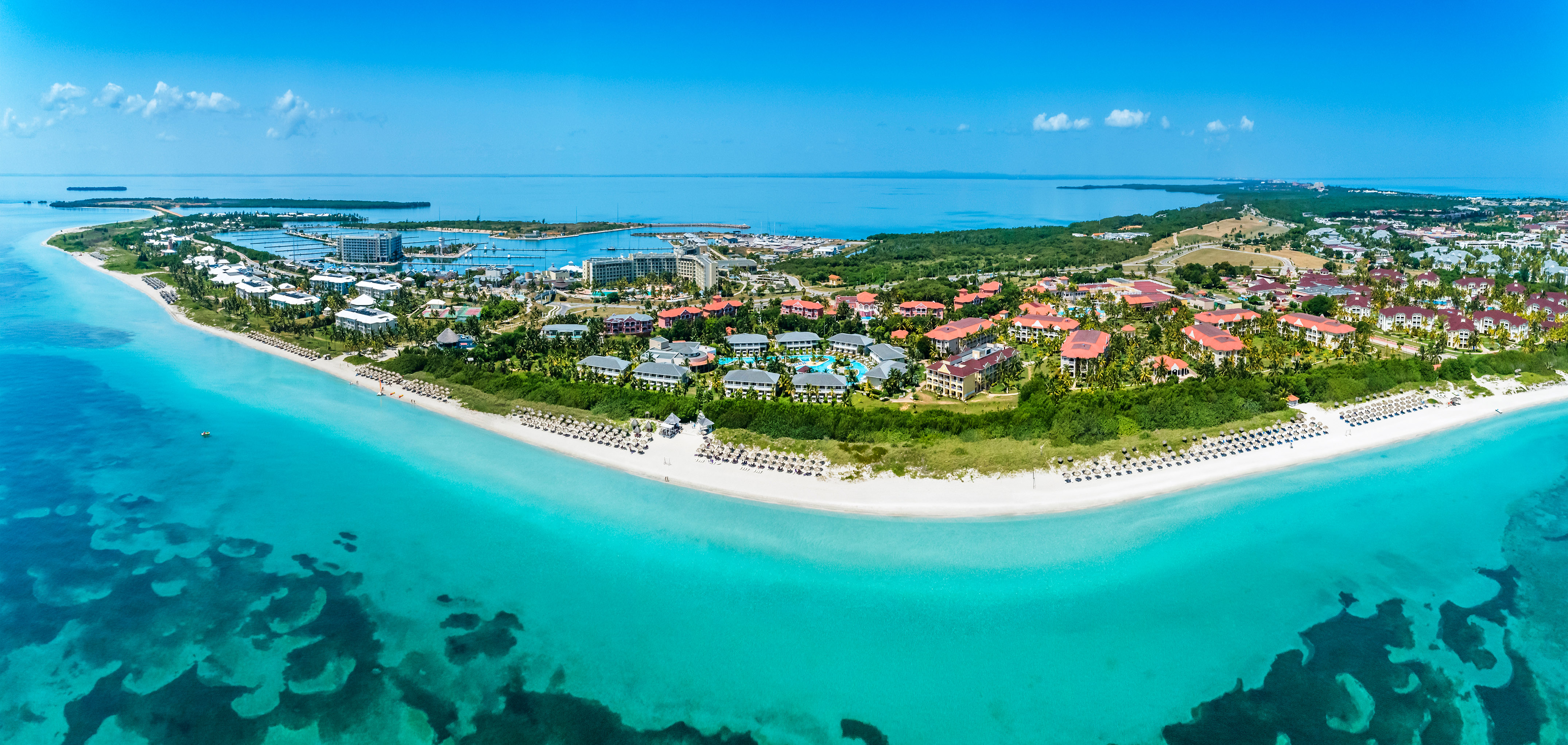 a beach with buildings and a body of water