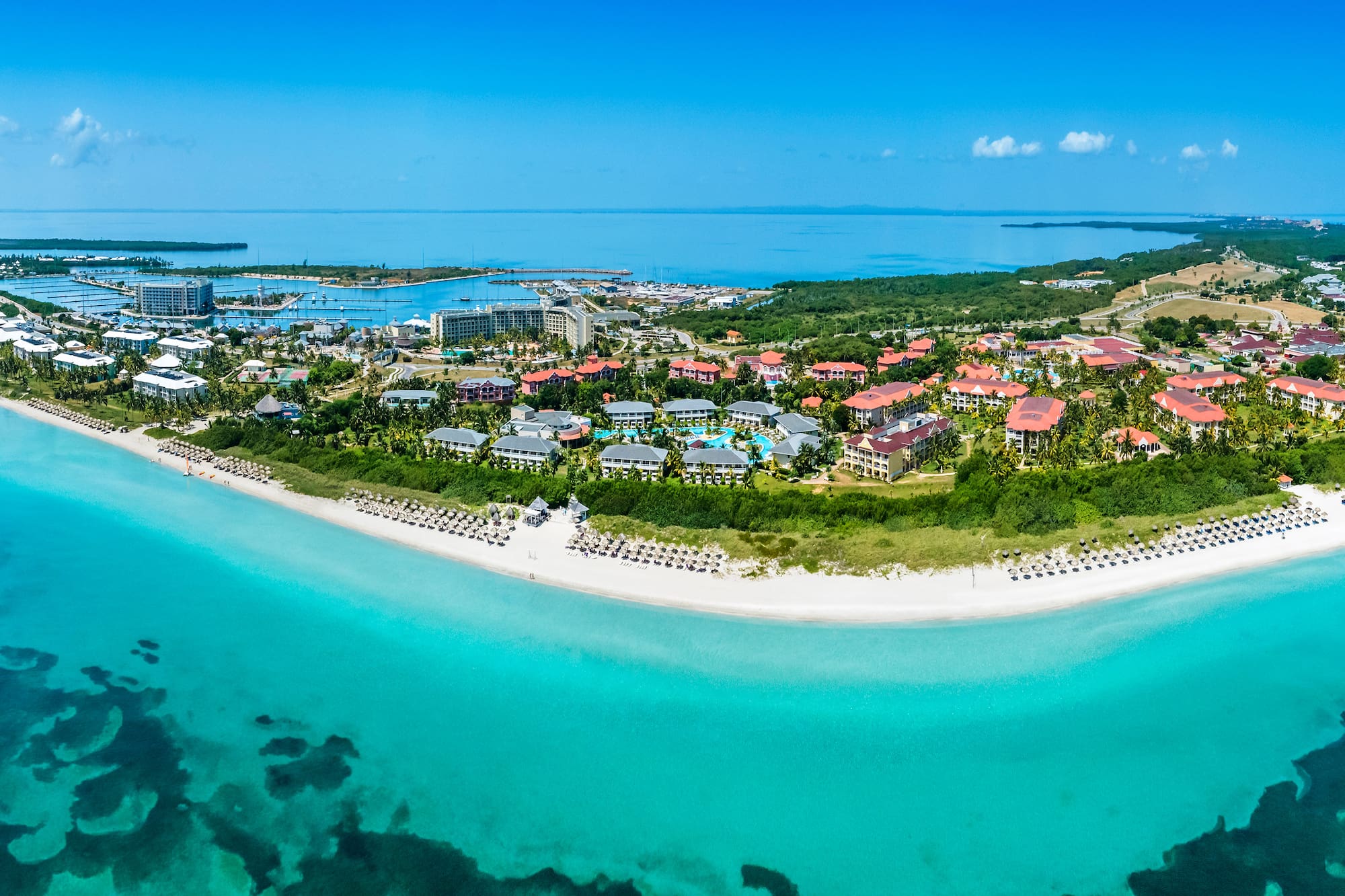 a beach with buildings and a body of water