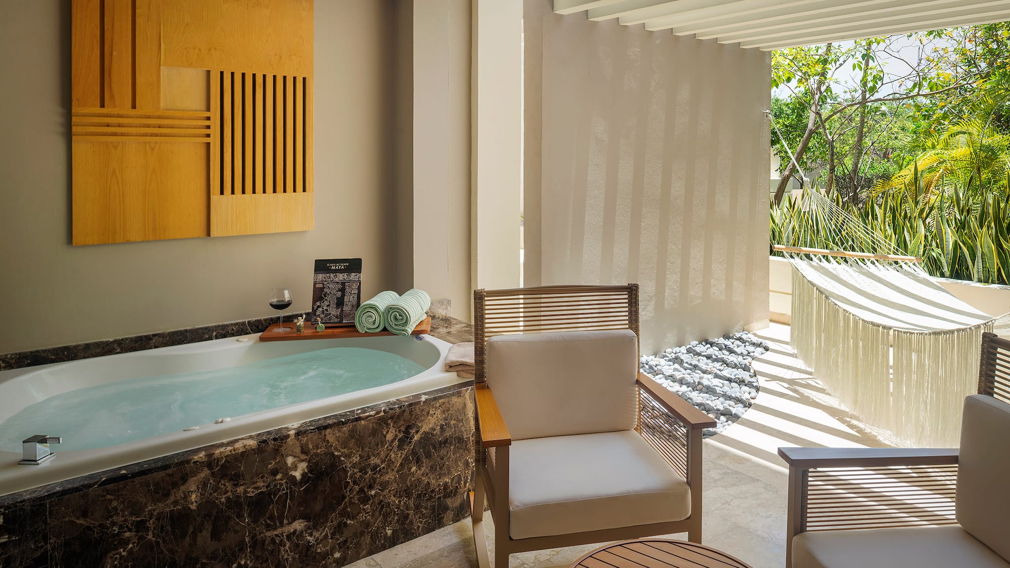 a room with a tub and chairs