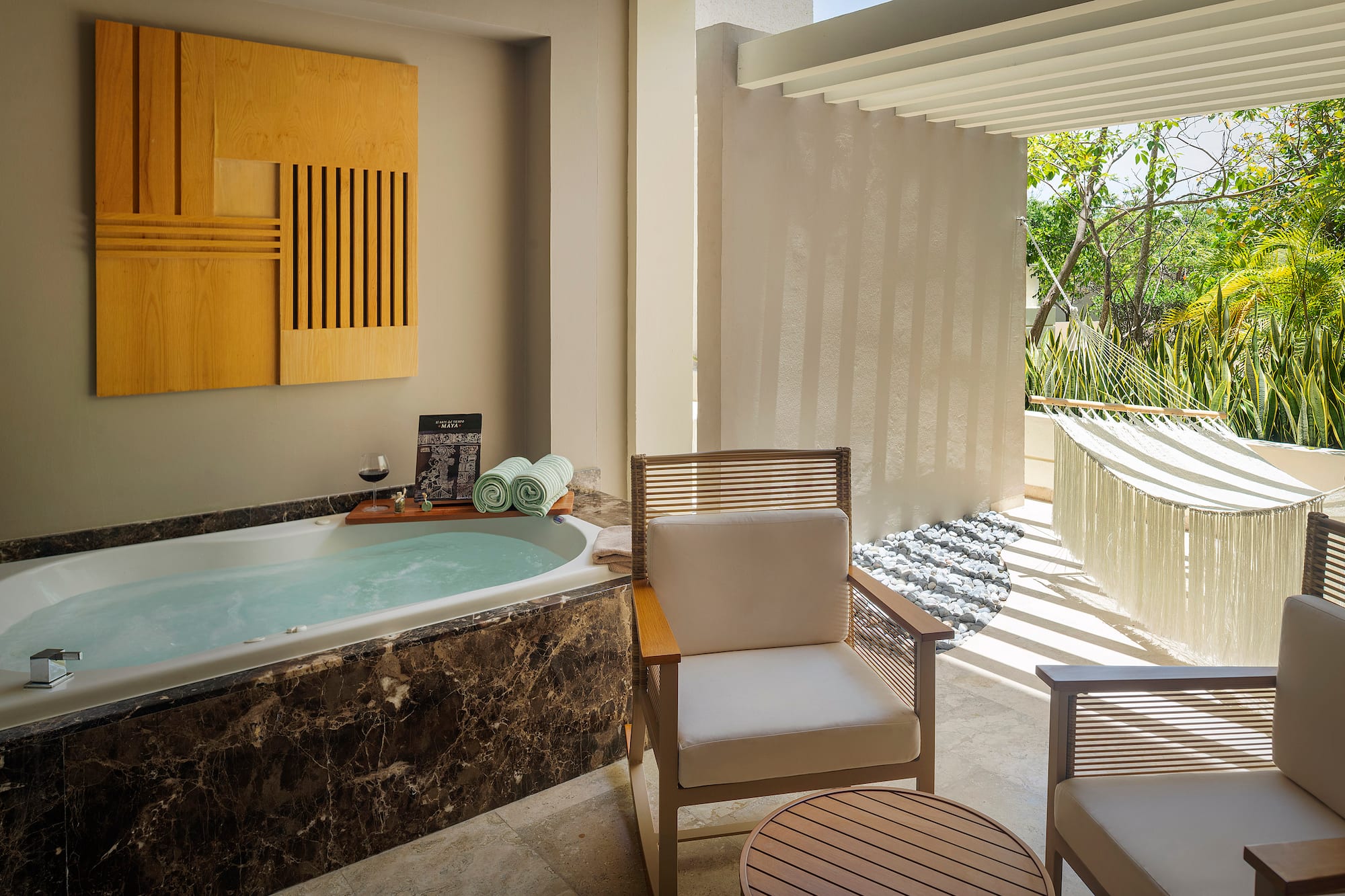 a room with a tub and chairs