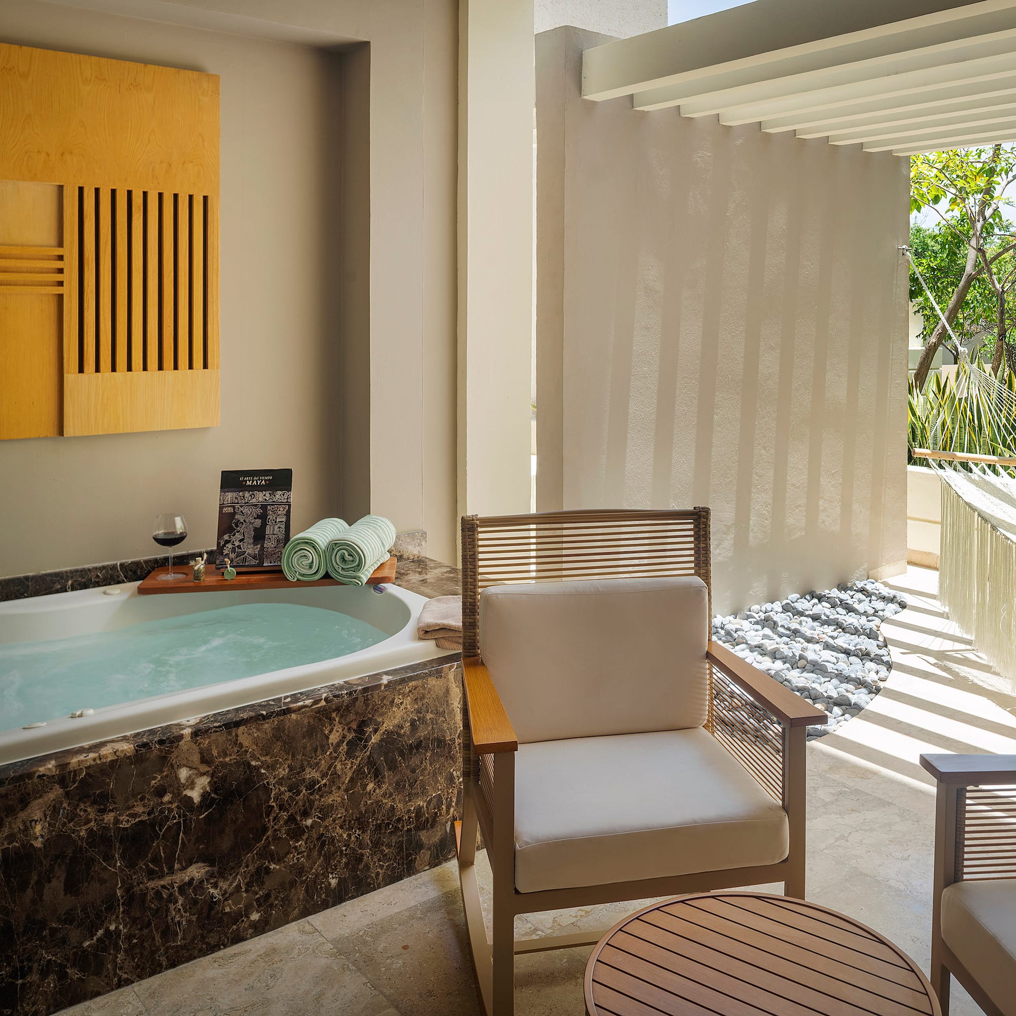 a room with a tub and chairs