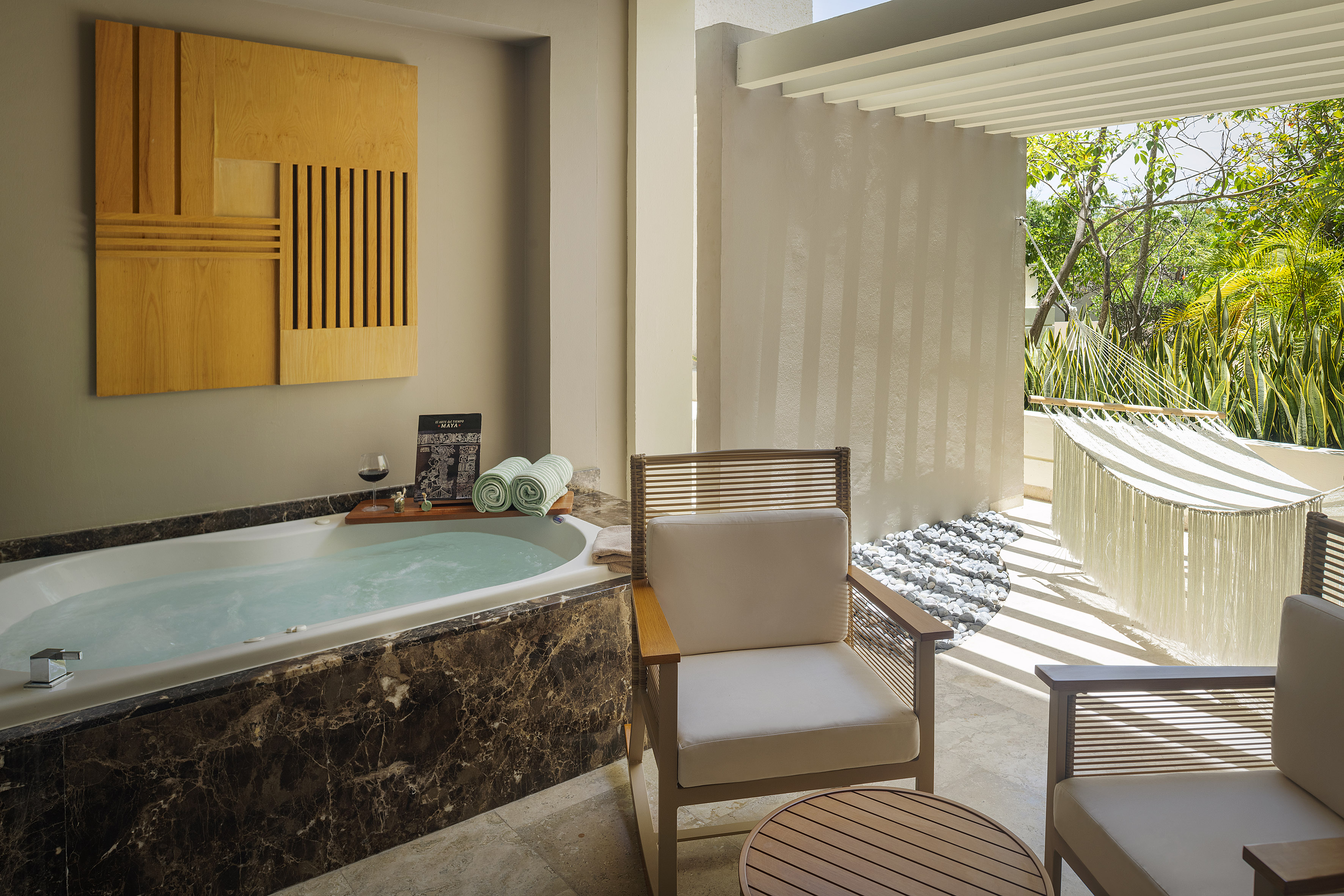 a room with a tub and chairs