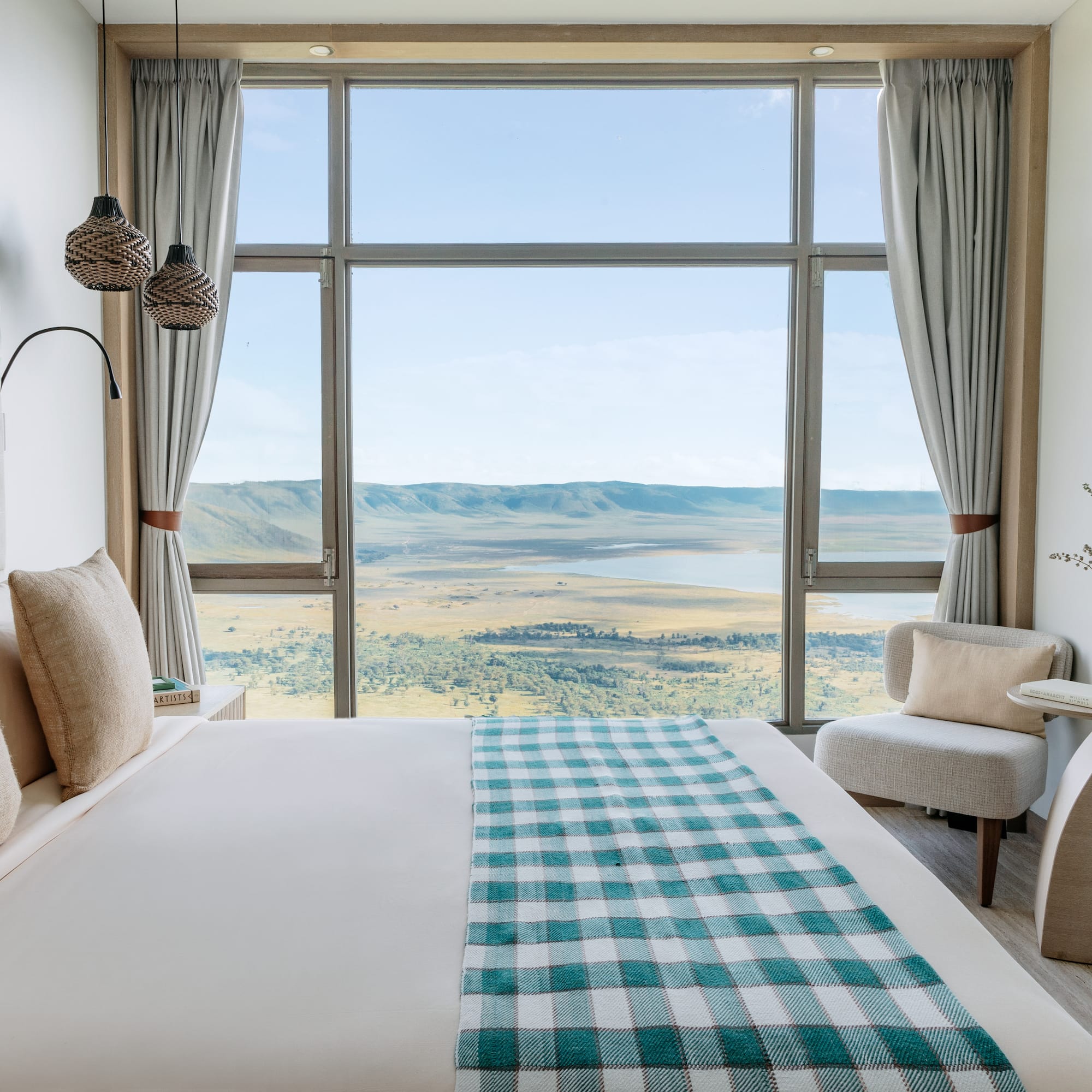 a room with a bed and a view of the valley