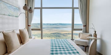 a room with a bed and a view of the valley