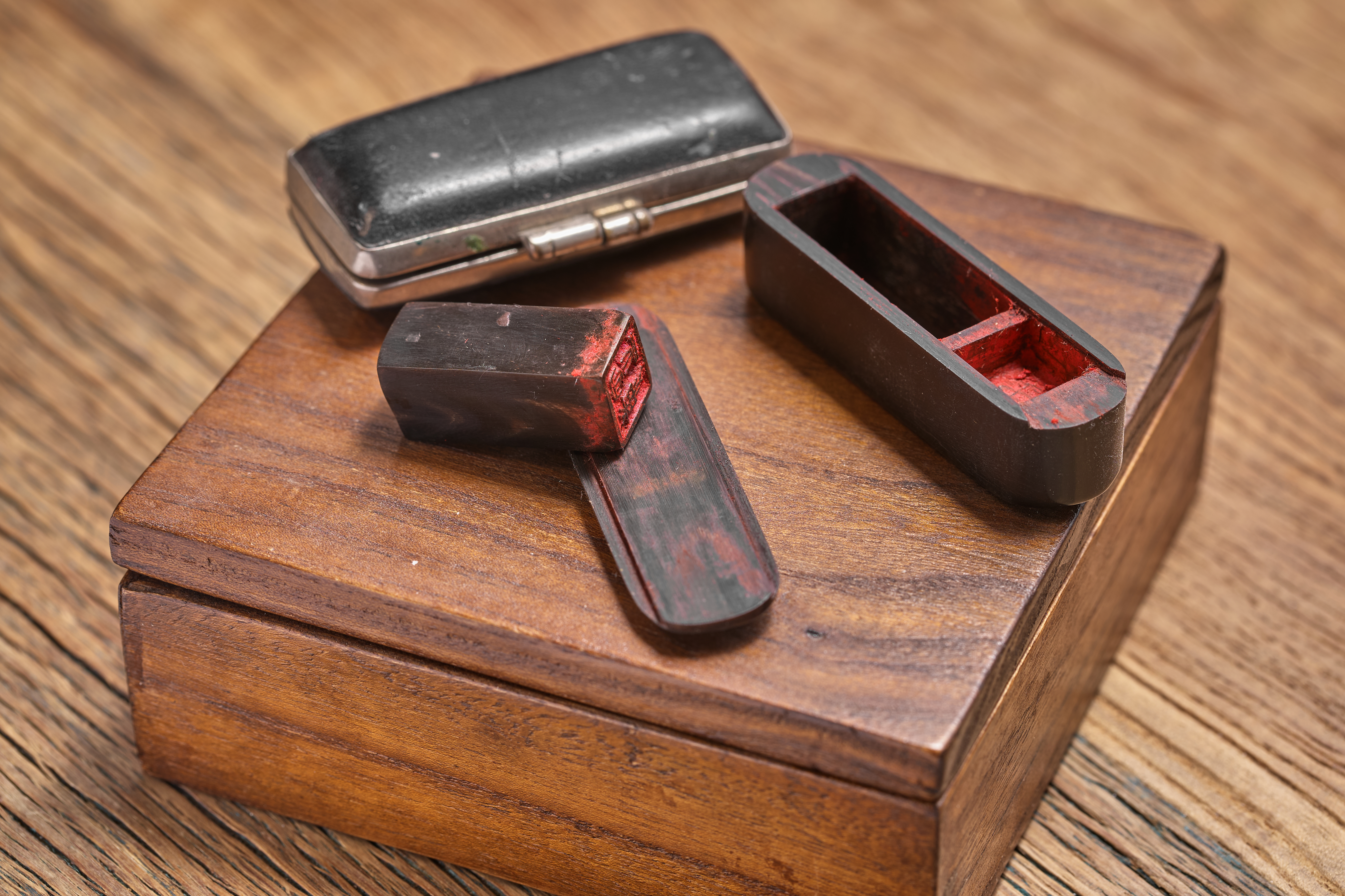 a wooden box with red and black objects on it