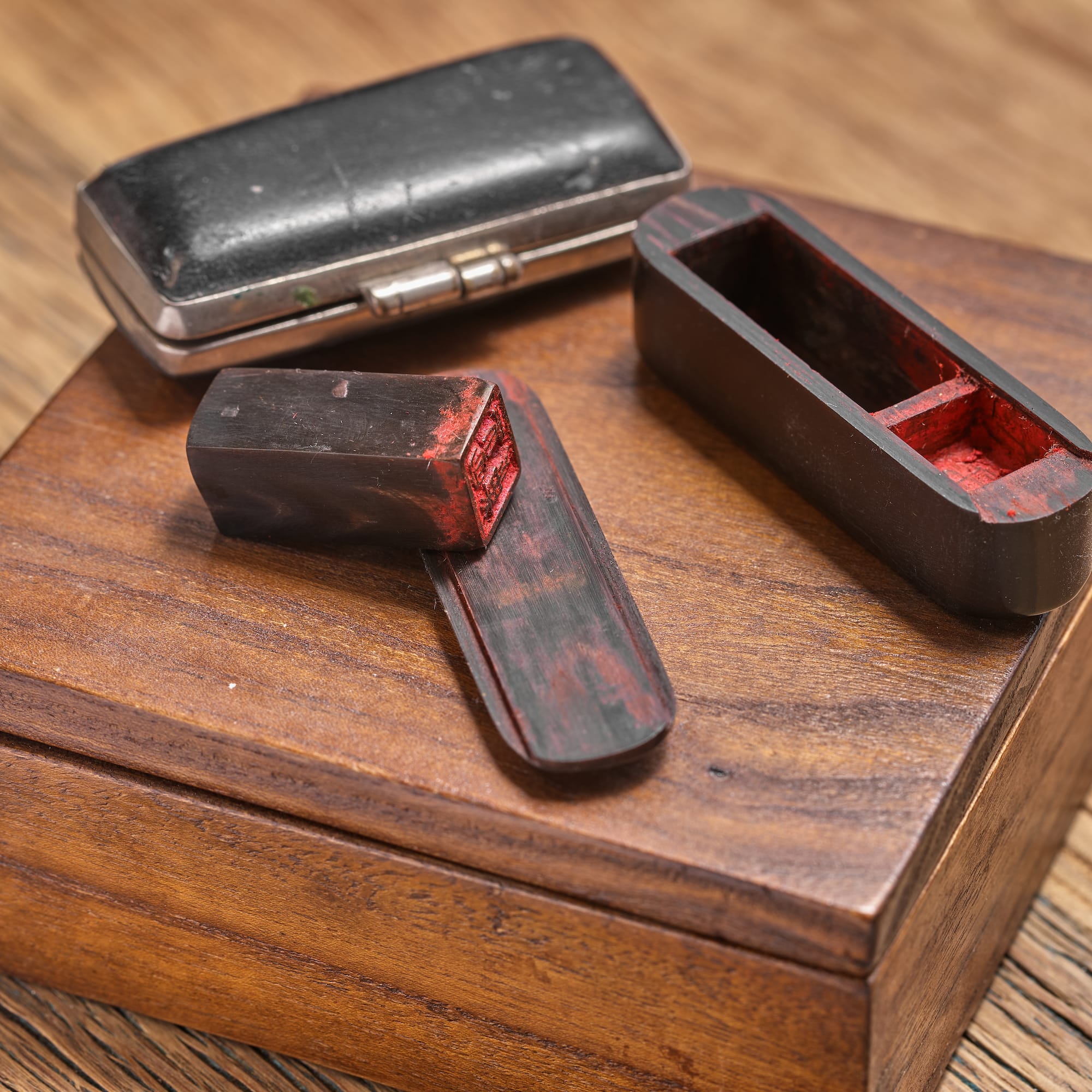 a wooden box with red and black objects on it