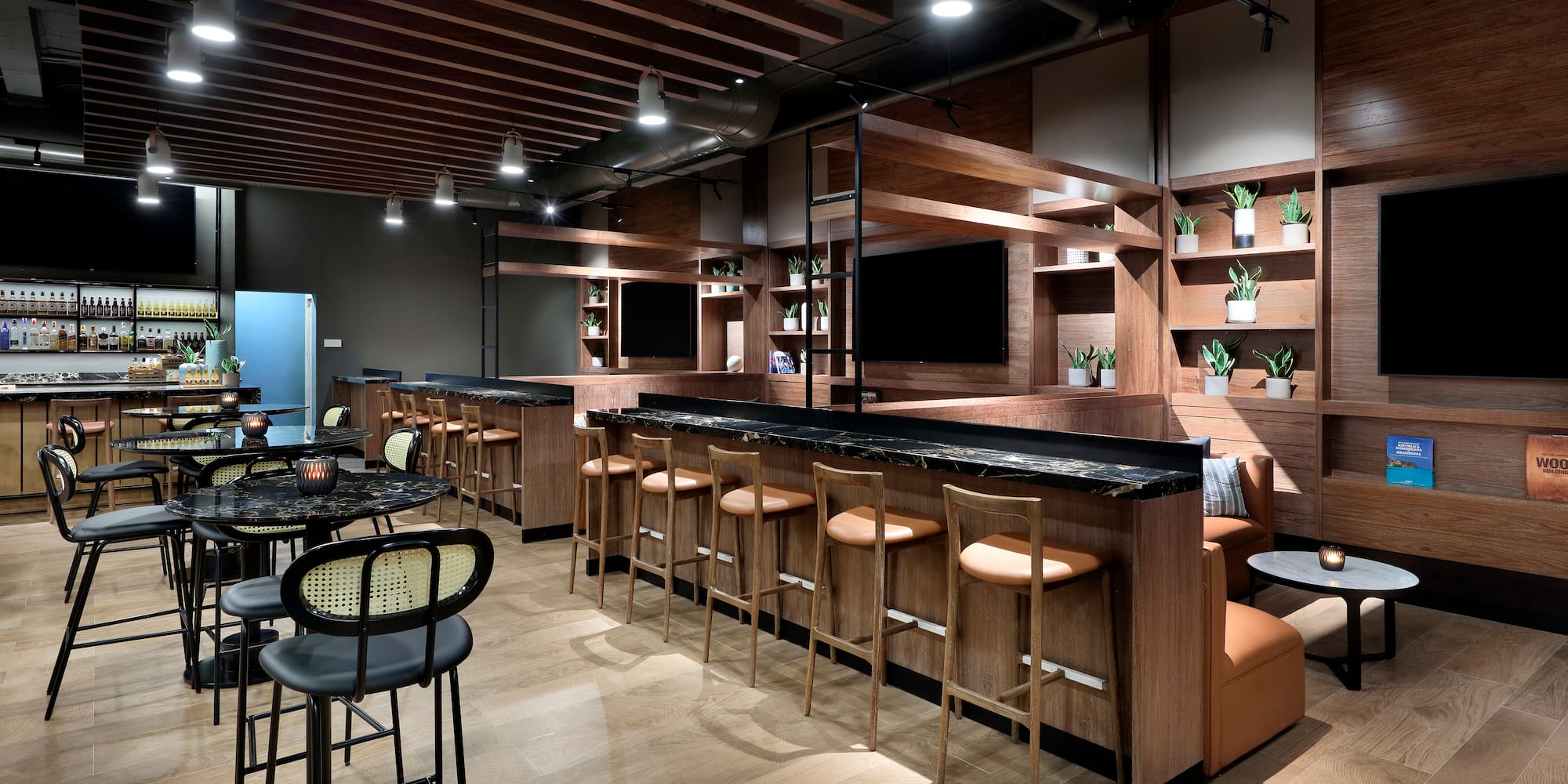 a room with a bar and chairs