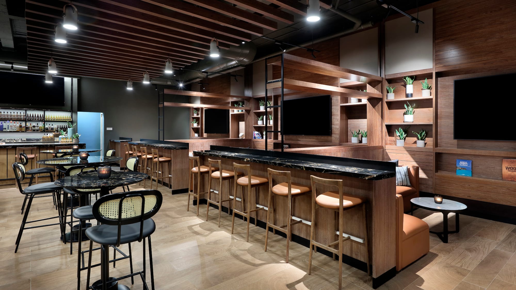 a room with a bar and chairs