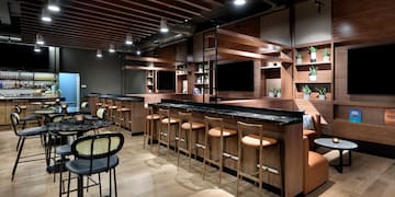 a room with a bar and chairs