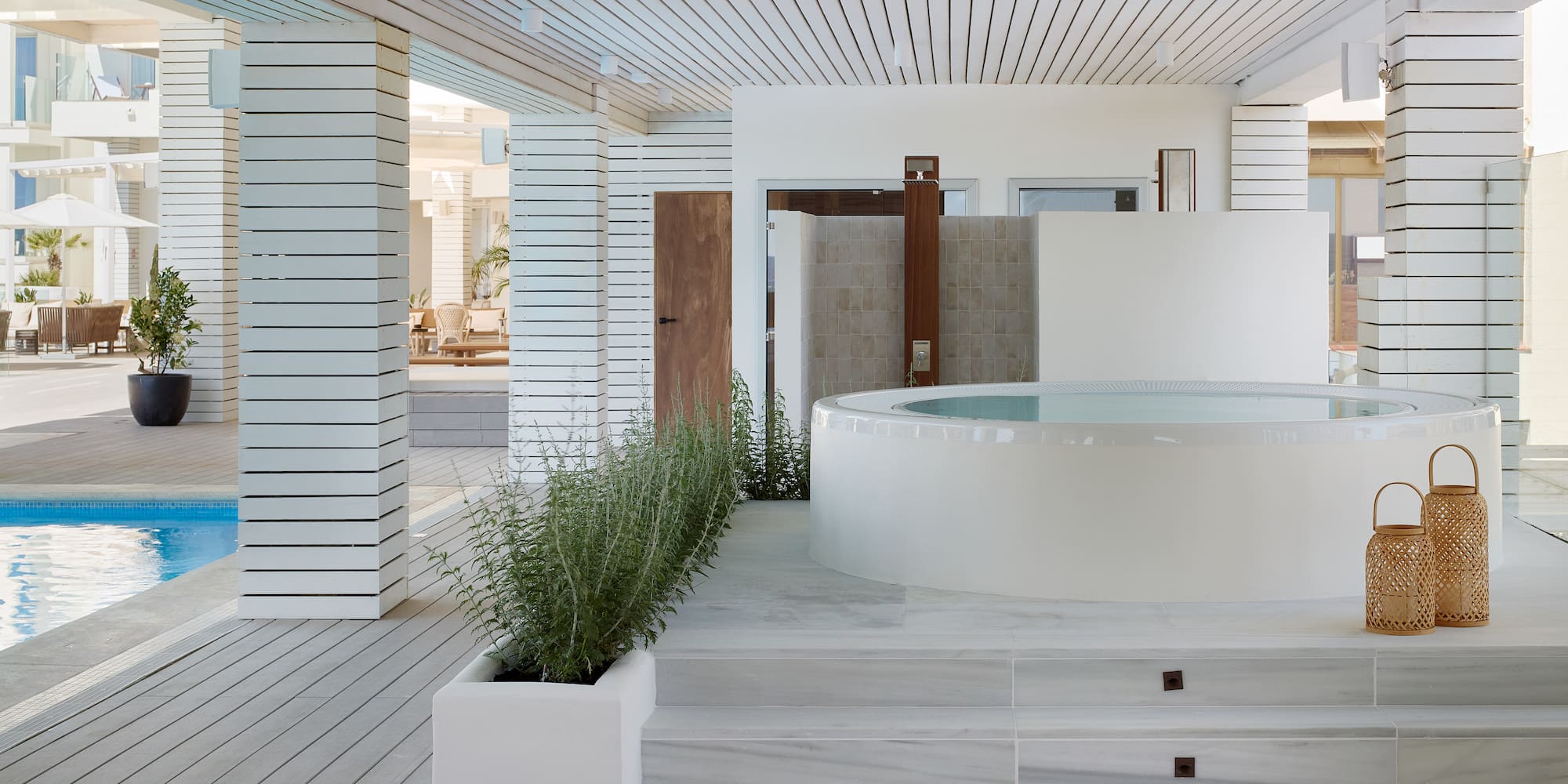 a white room with a hot tub and plants
