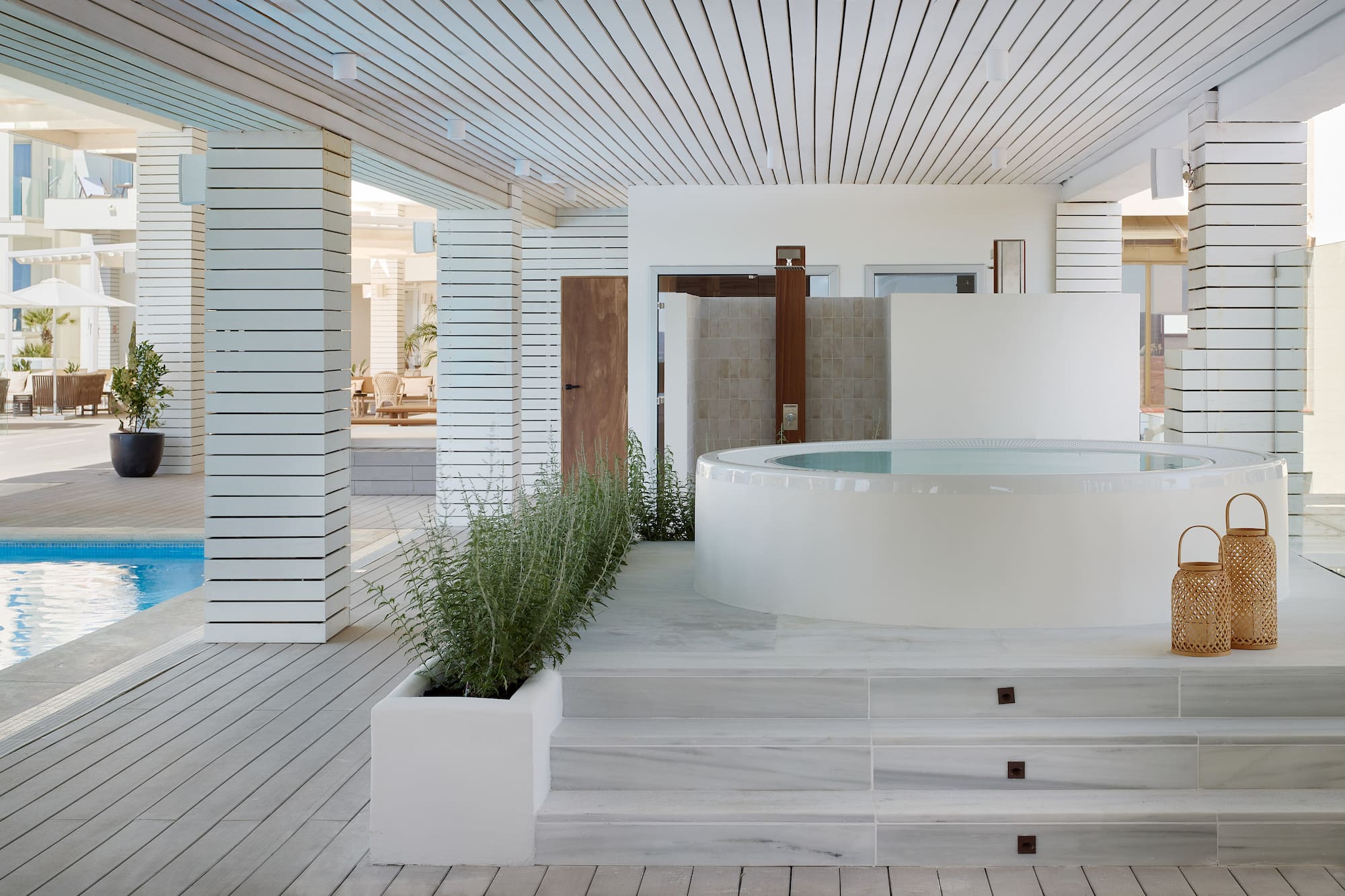 a white room with a hot tub and plants