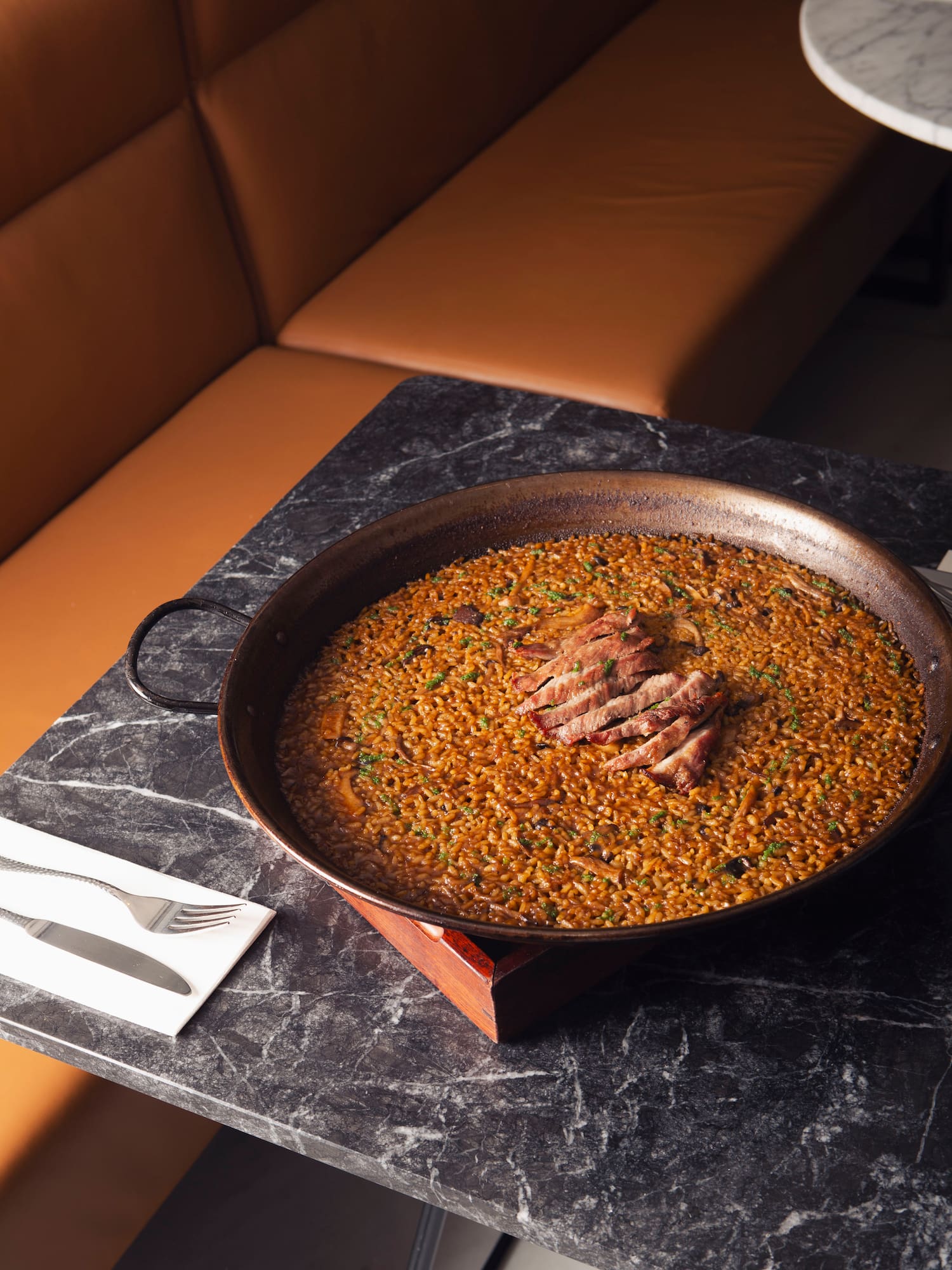 a large pan of food on a marble table