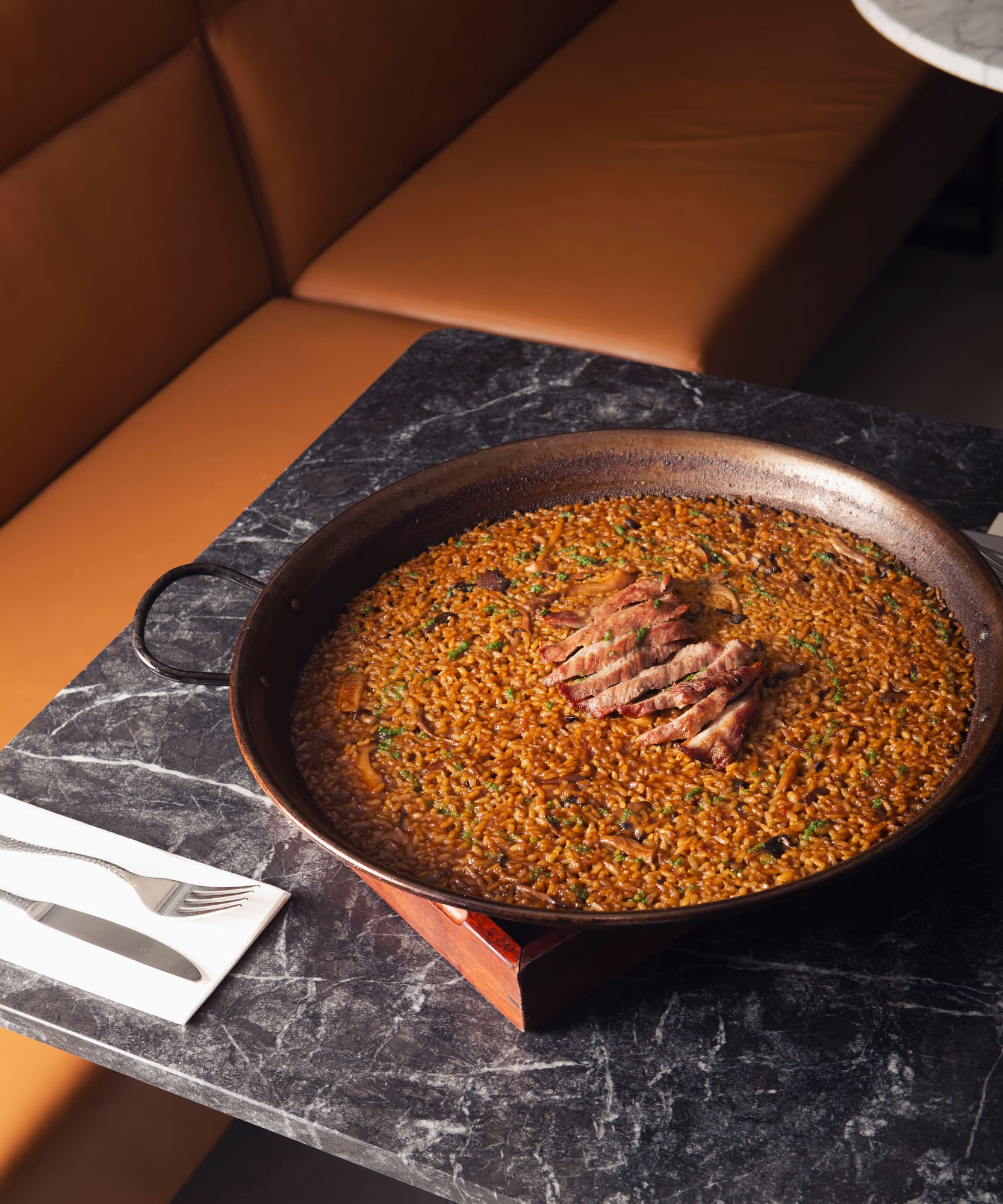 a large pan of food on a marble table