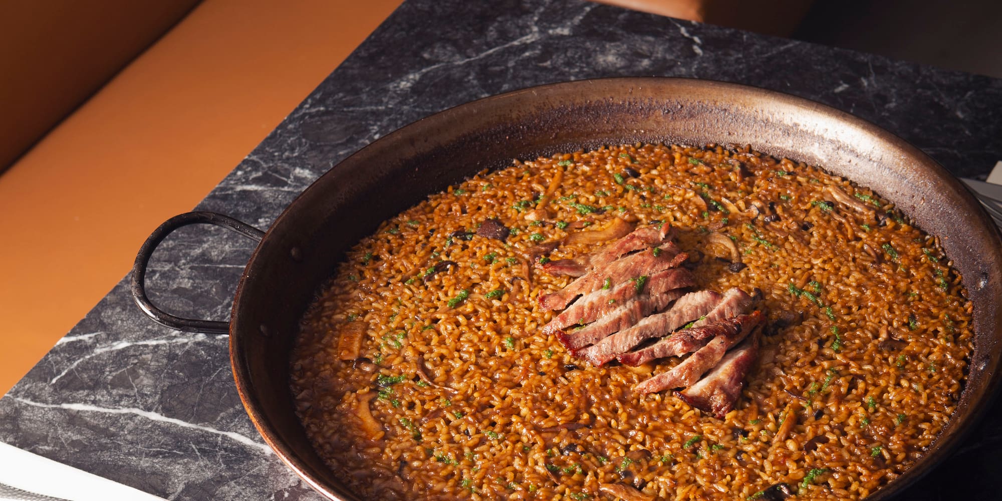 a large pan of food on a marble table