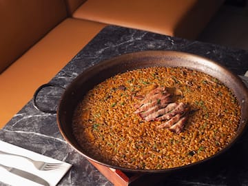 a large pan of food on a marble table