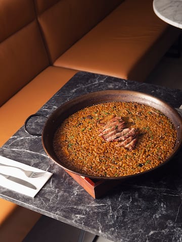 a large pan of food on a marble table