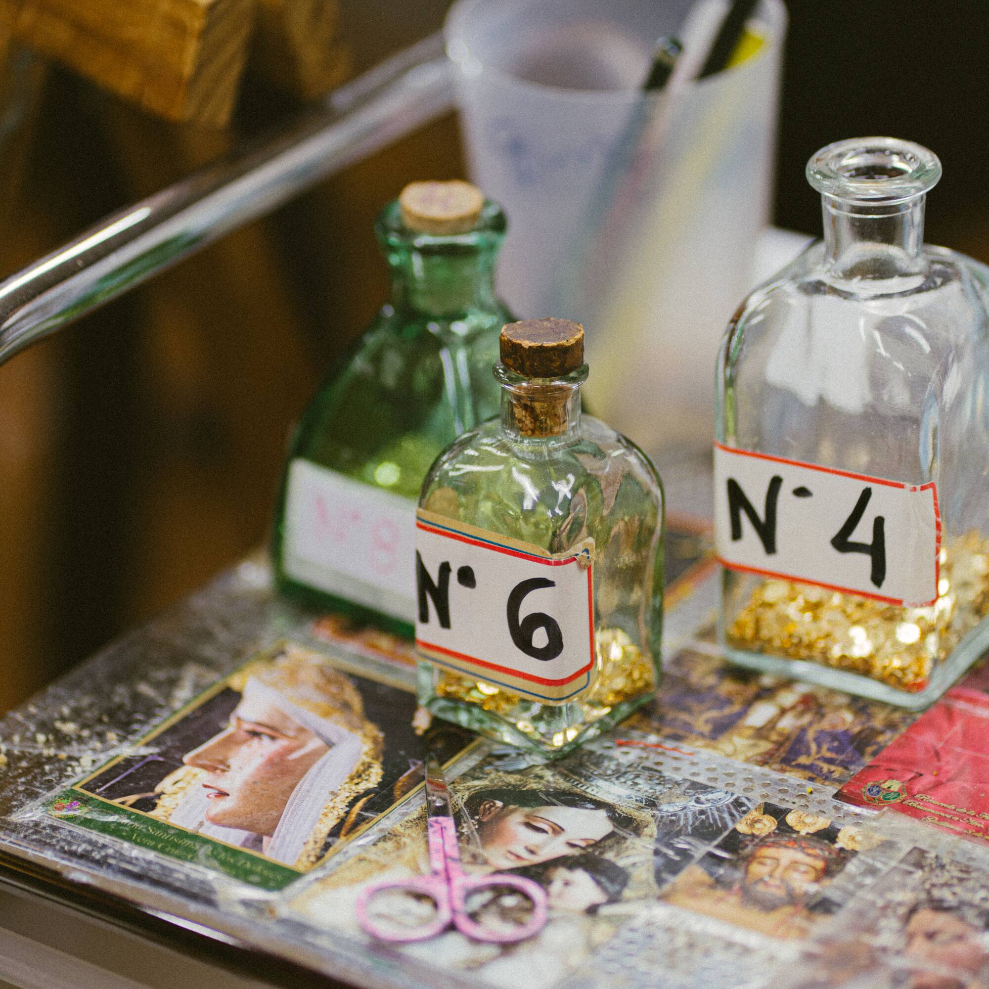 bottles with numbers and a pair of scissors on a table
