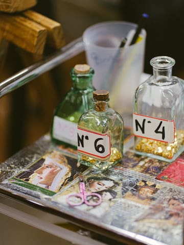 bottles with numbers and a pair of scissors on a table