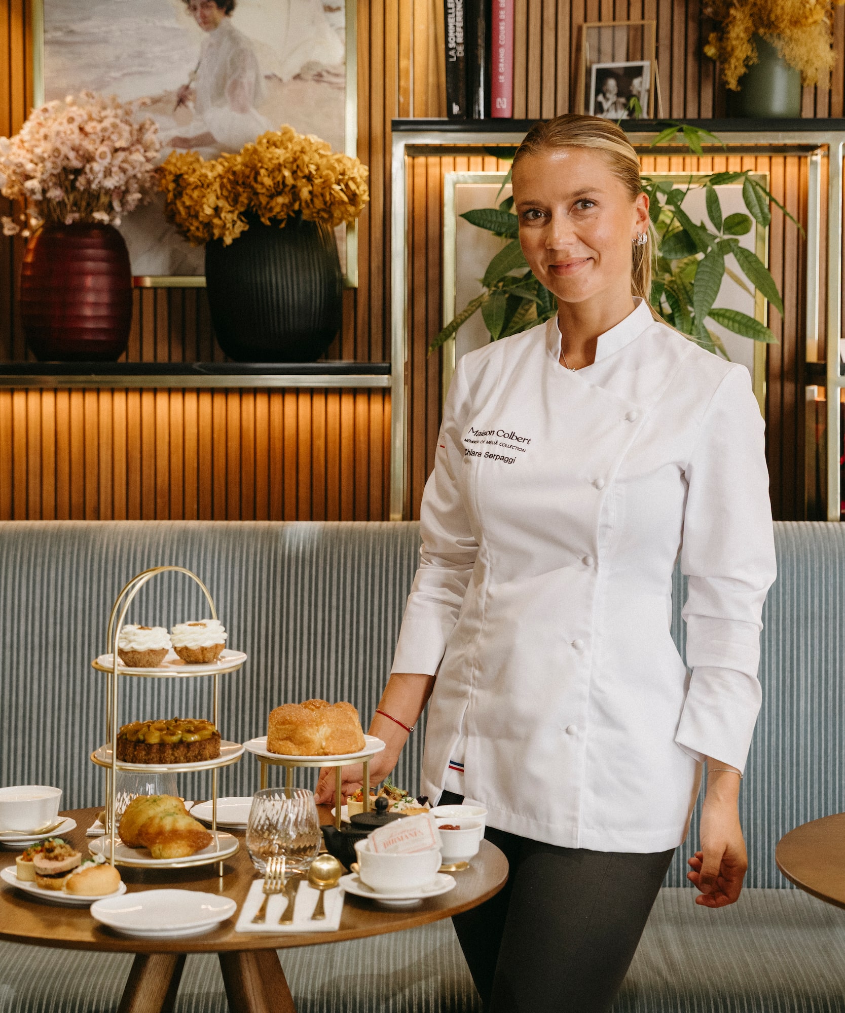 Chef Chiara Serpaggi with Maison Colbert afternoon tea, pastries, and savories.