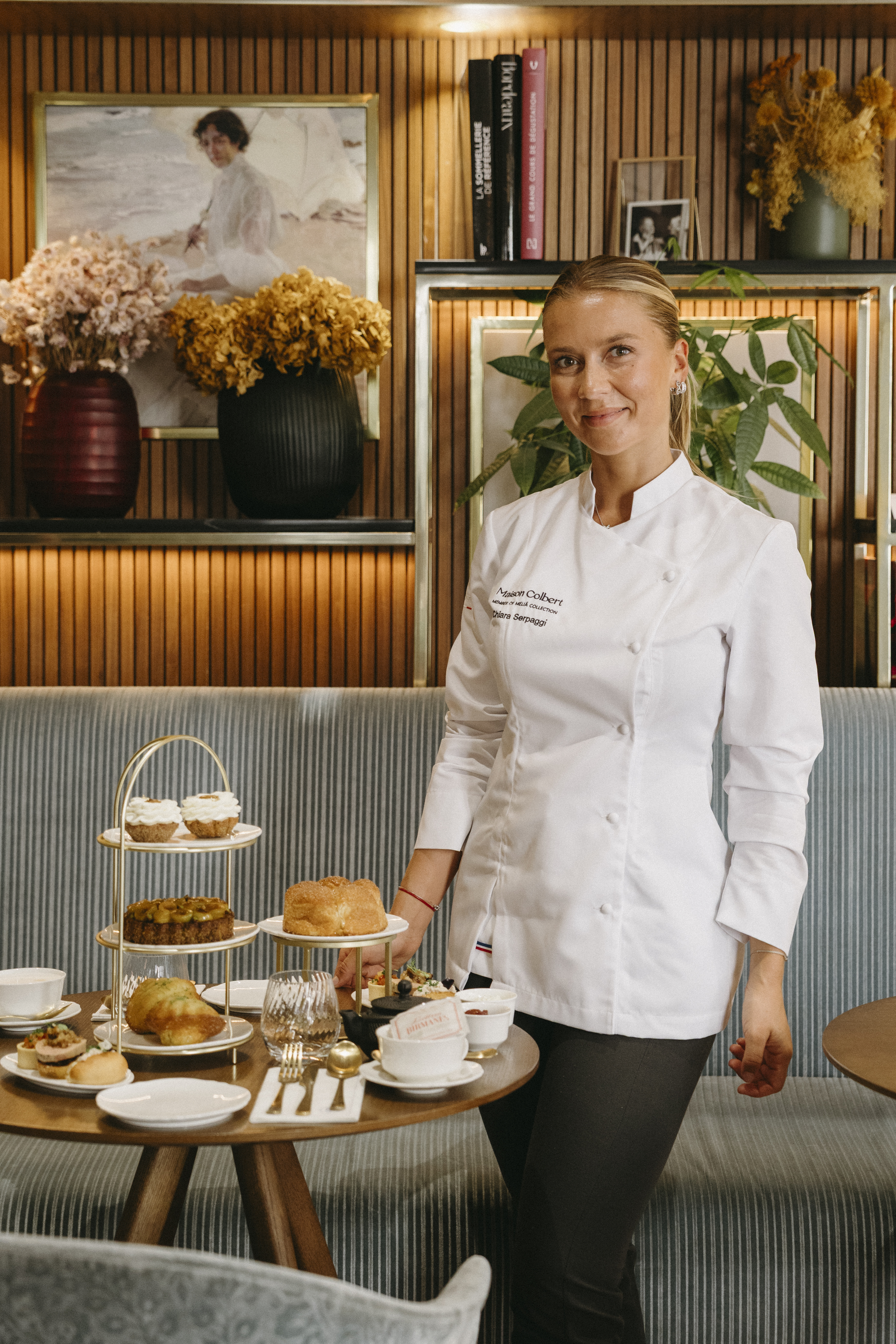 Chef Chiara Serpaggi with Maison Colbert afternoon tea, pastries, and savories.