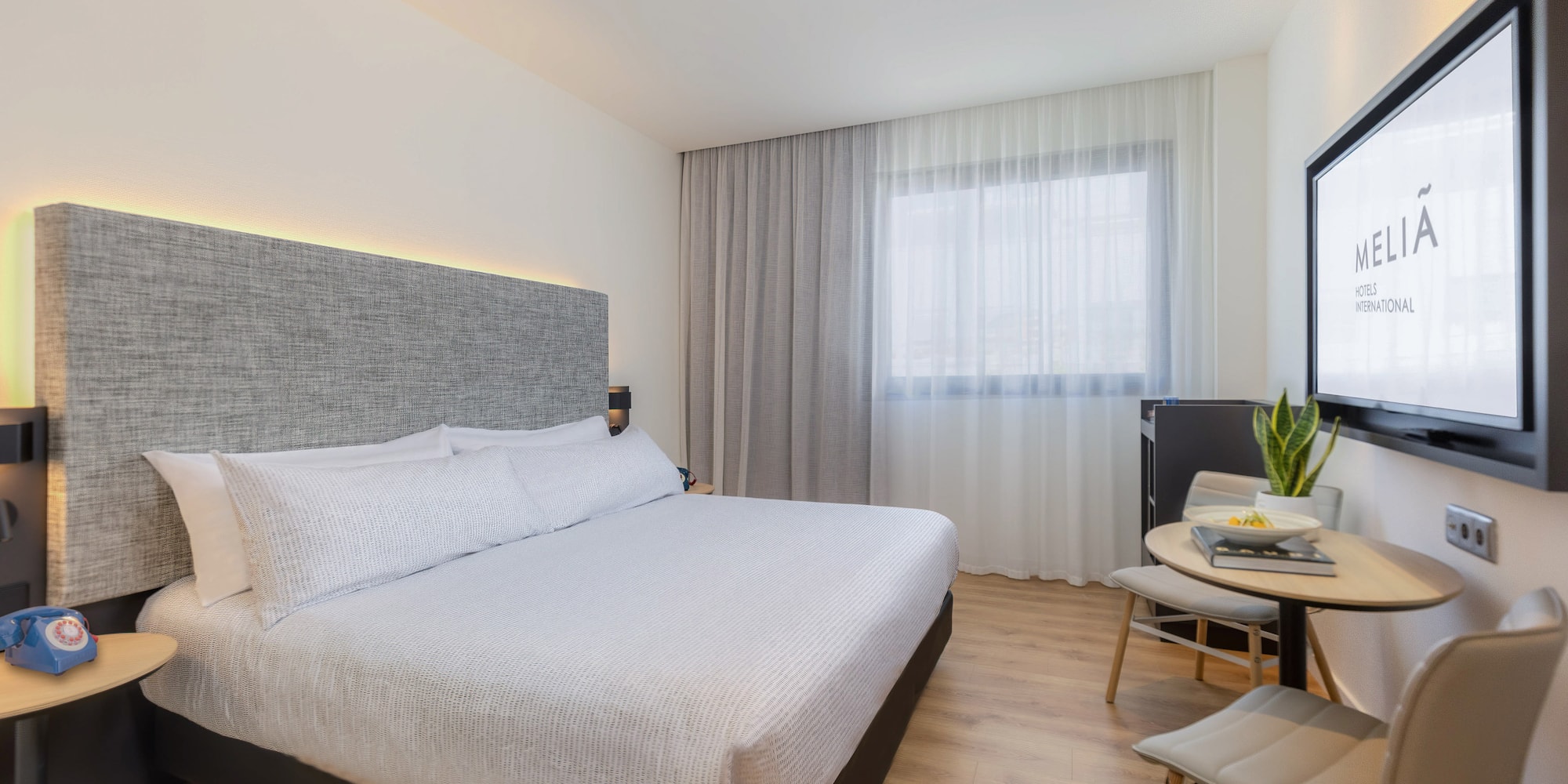 a bedroom with a bed and a table