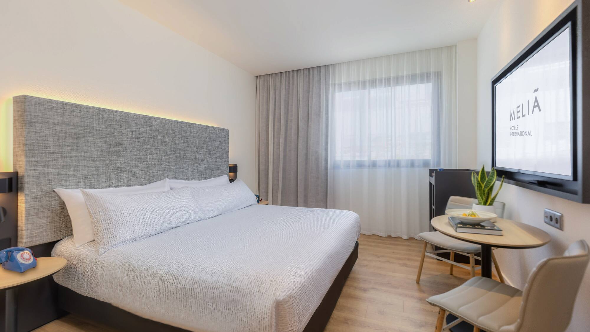 a room with two beds and a table