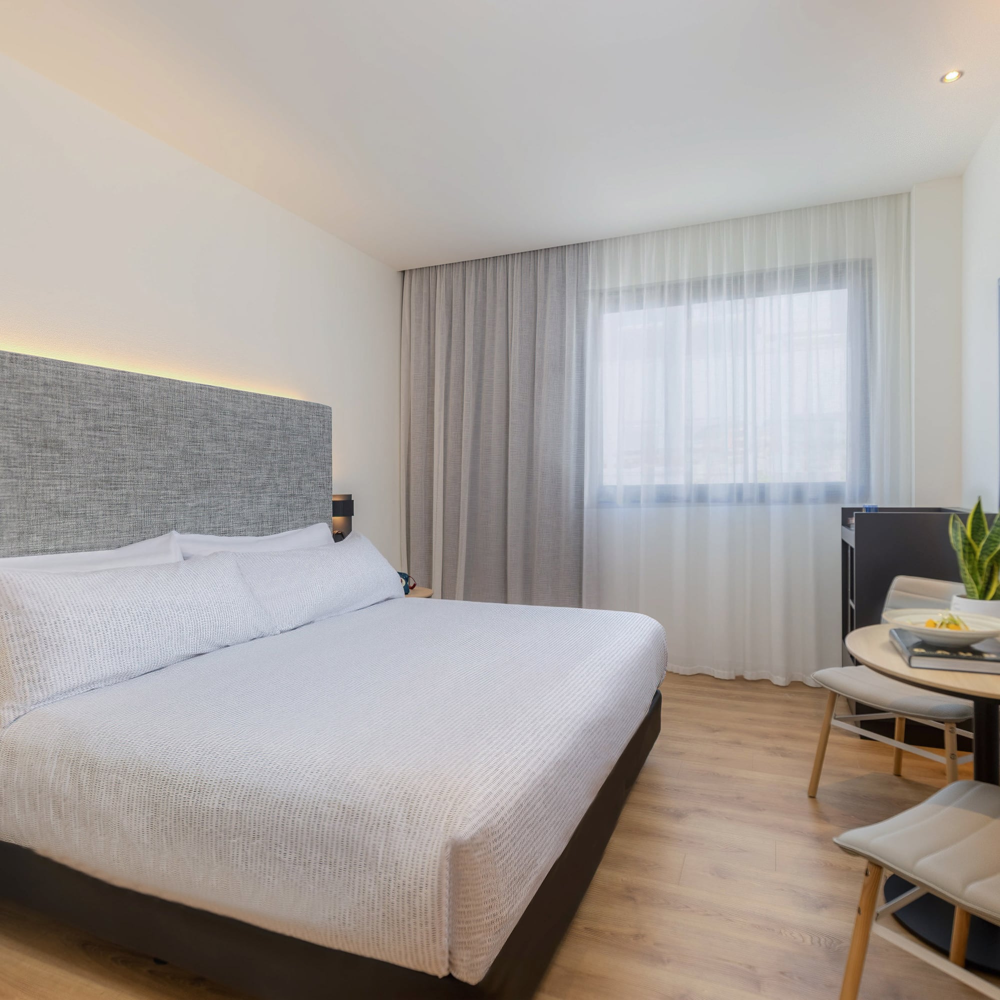 a bedroom with a bed and a table