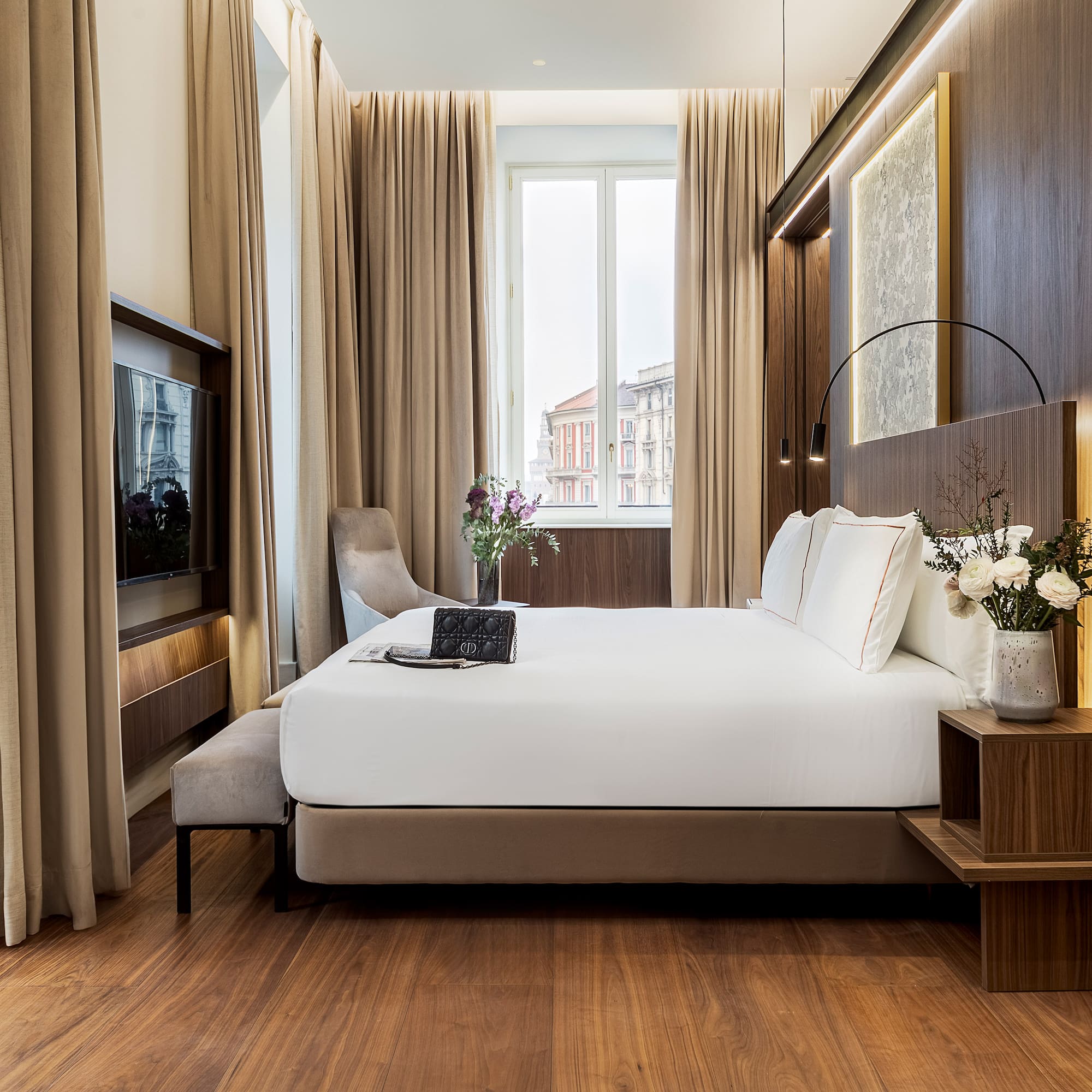 a room with a bed and a television