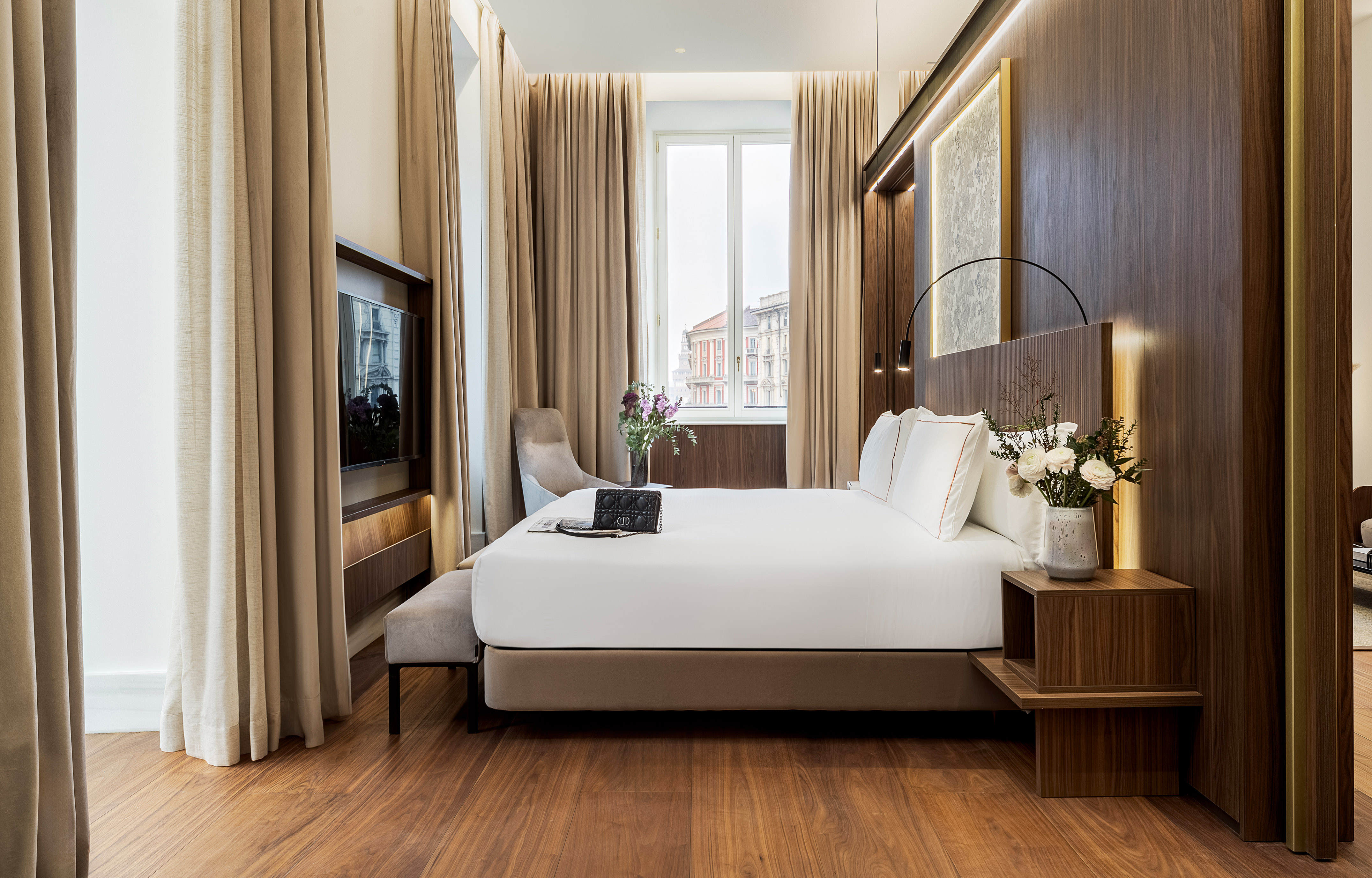 a room with a bed and a television