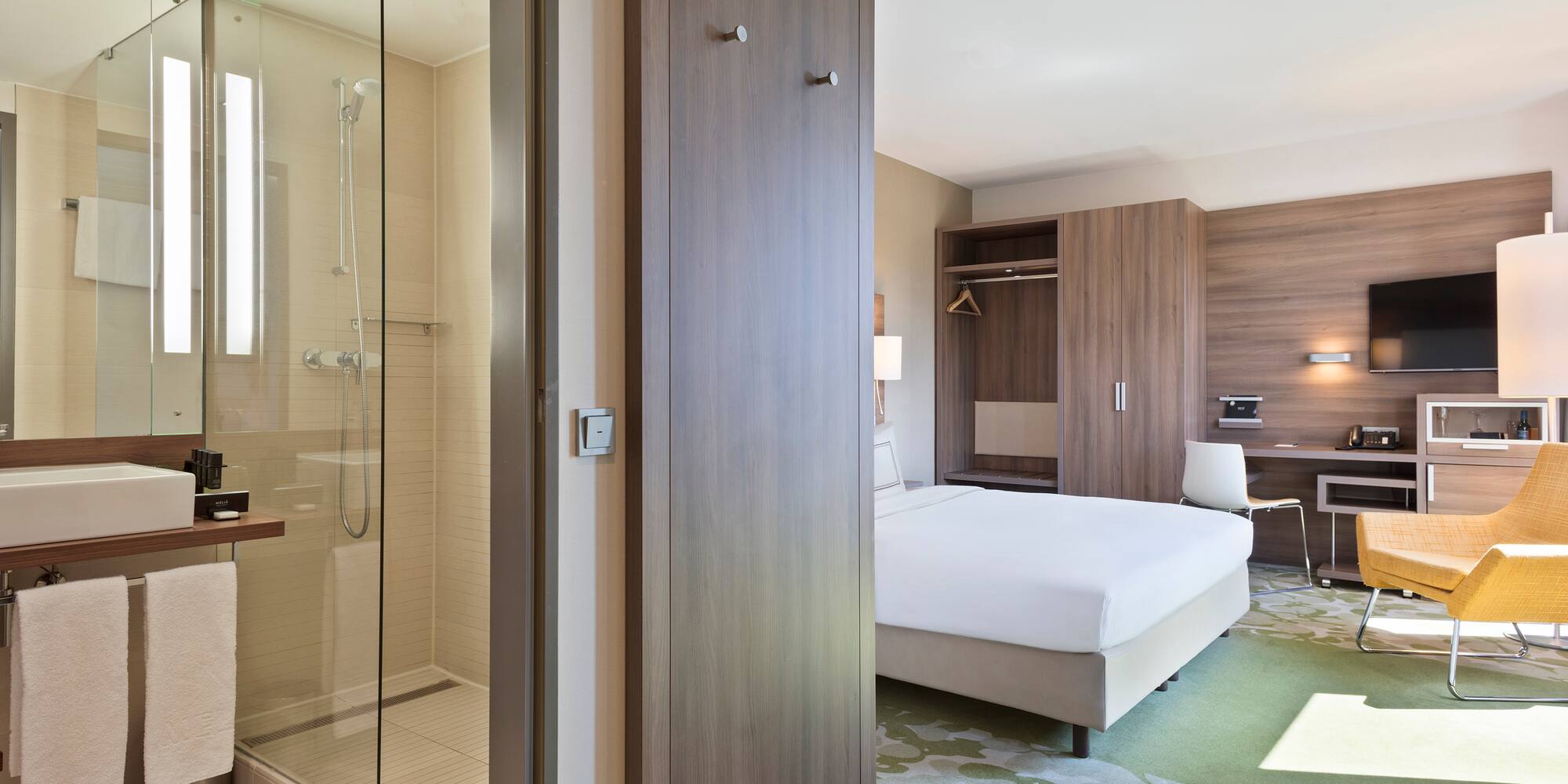 a room with a bed and a glass shower