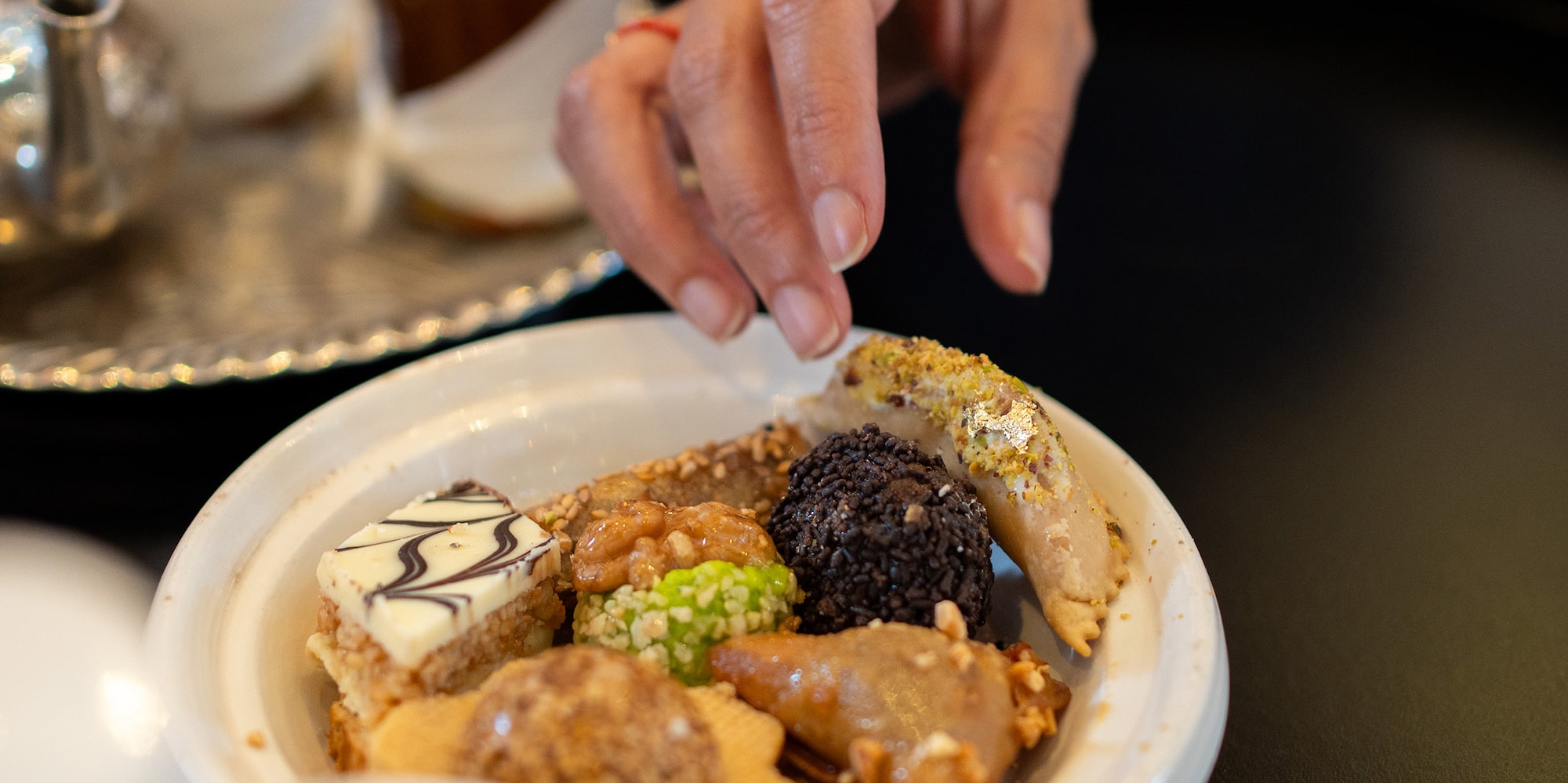 a hand reaching for food in a bowl