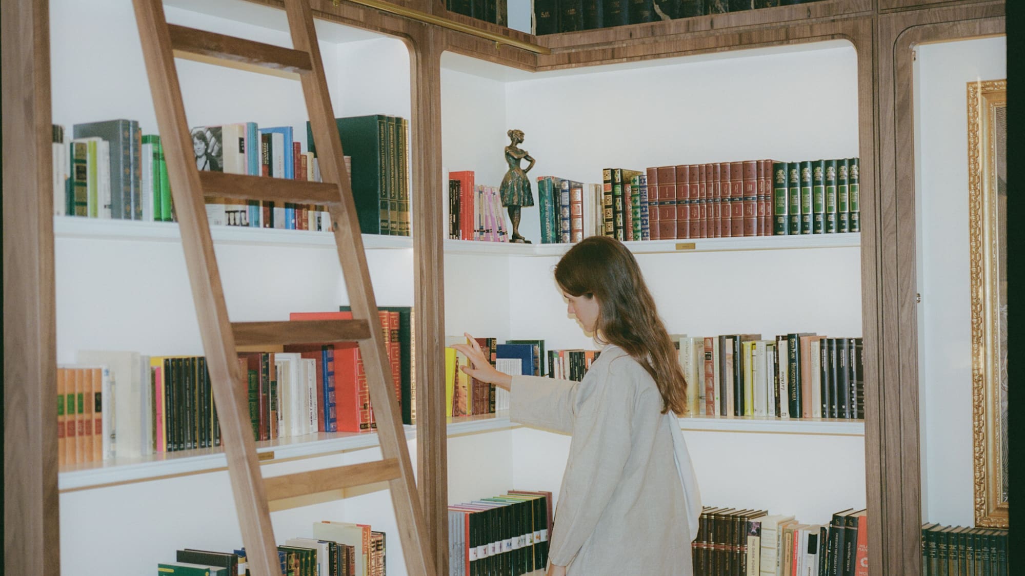 a woman standing in a library