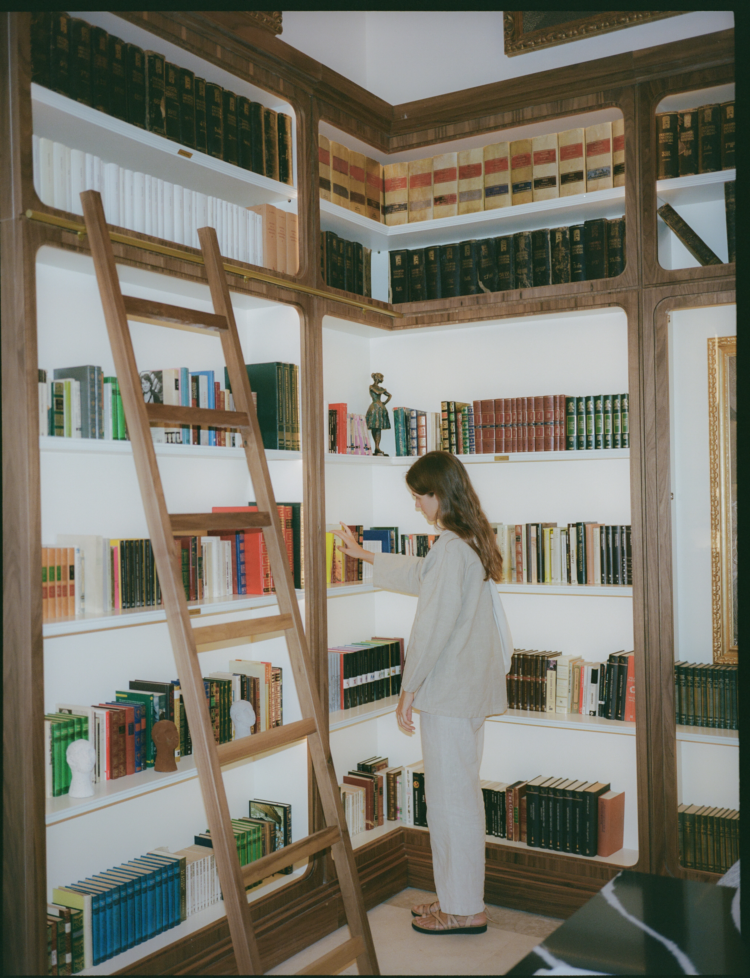 a woman standing in a library